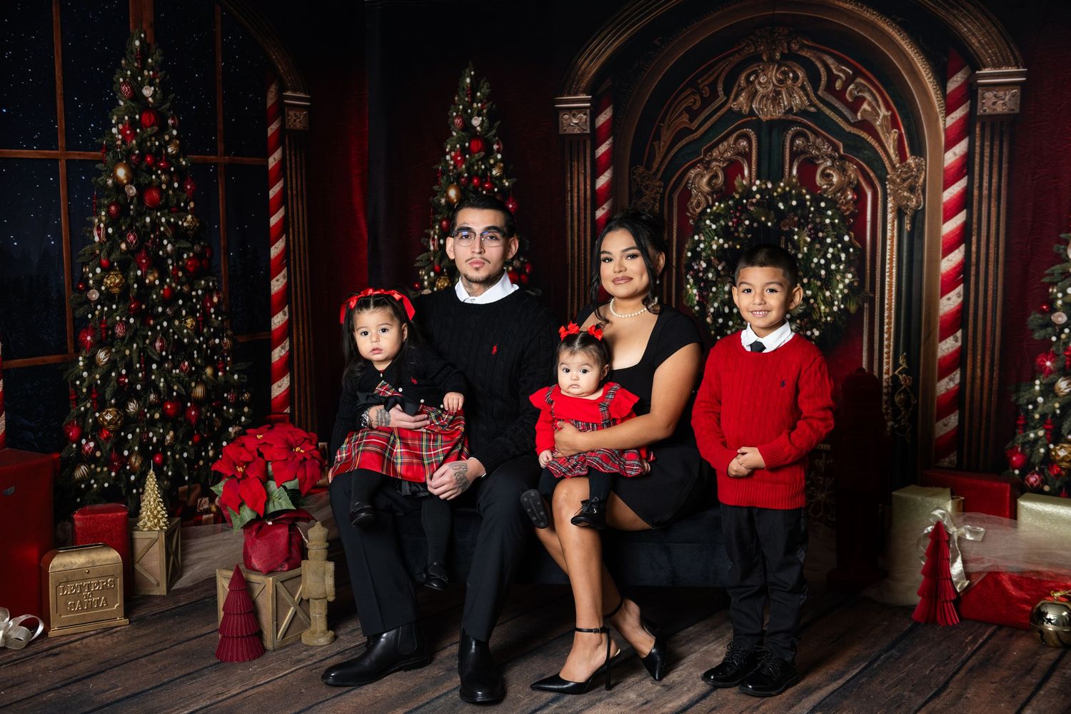Holiday family portraits in front of decorated Christmas trees and candy cane props.