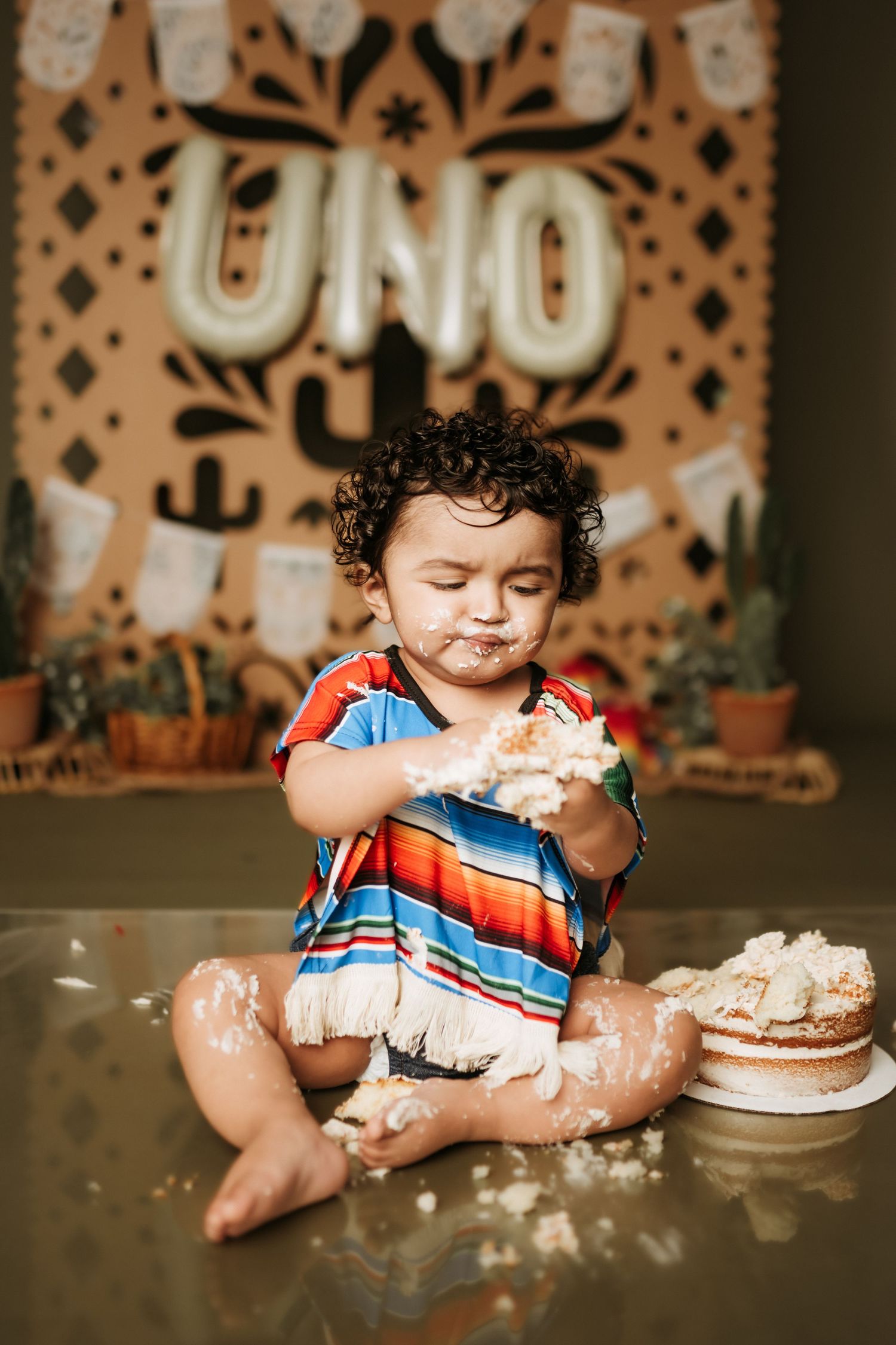 Cake smash photography session with Mexican fiesta themed decorations.