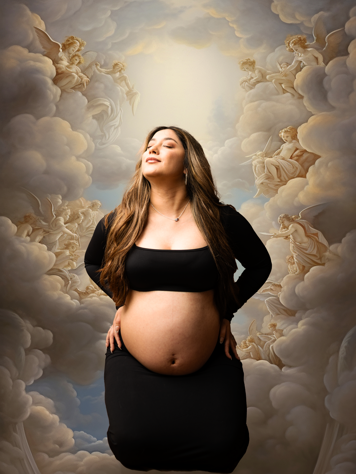 Dramatic maternity portrait against painted cloud backdrop wearing black dress.