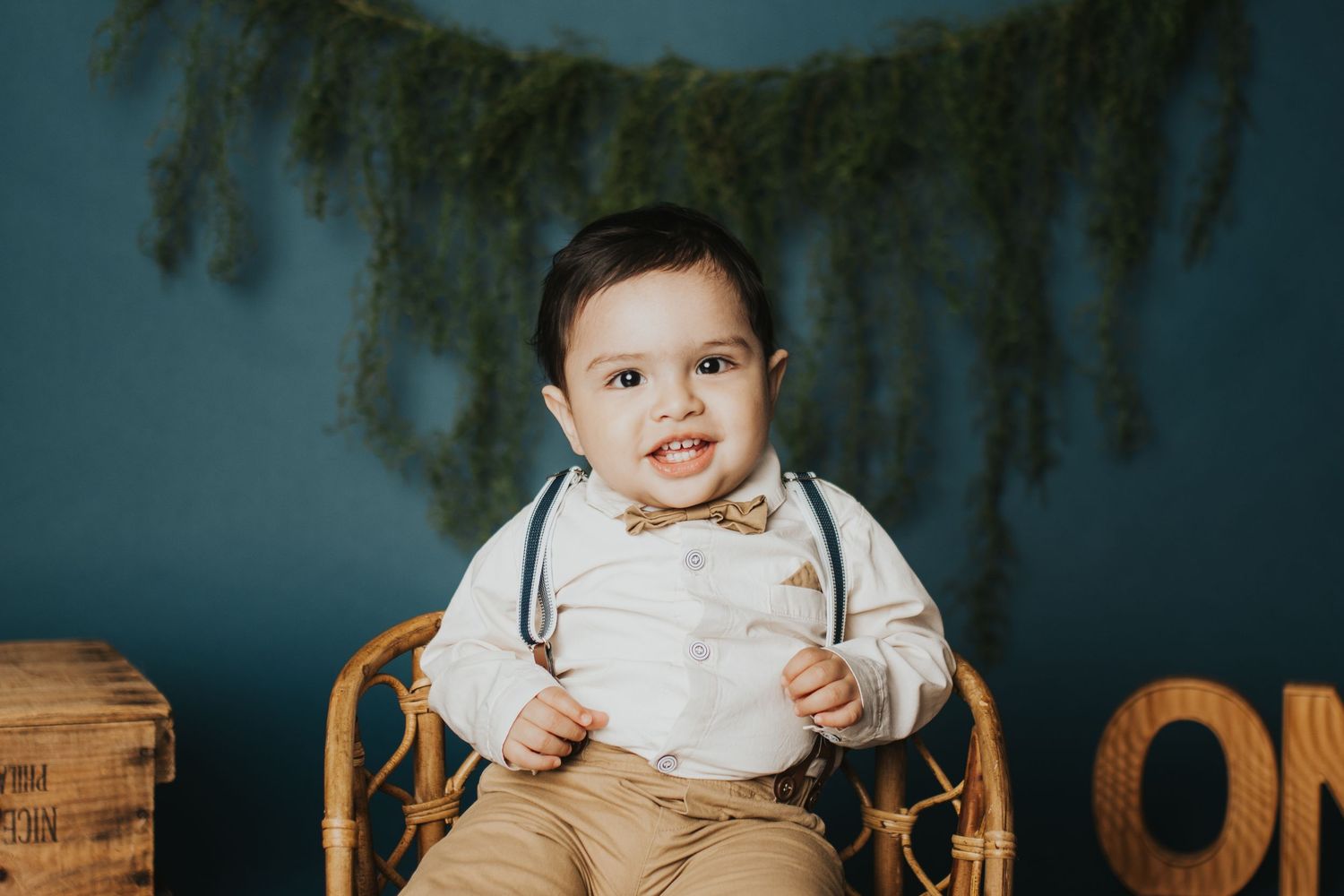 Dark moody cake smash photography setup with rustic wooden elements.