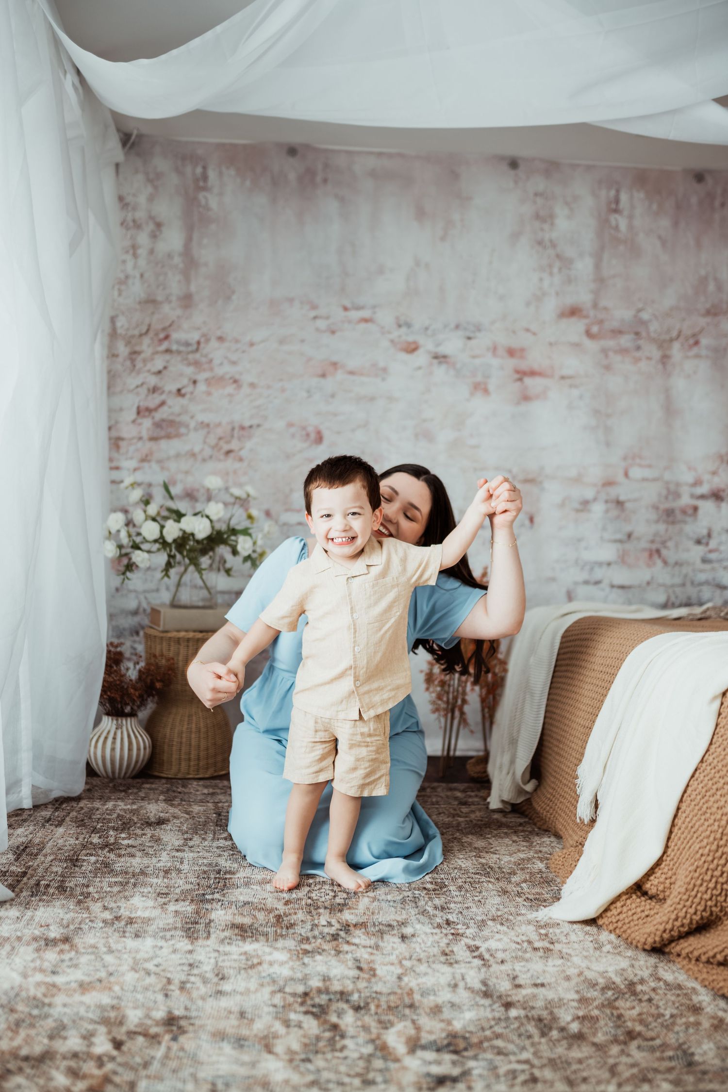 A playful sequence of candid moments on a beige couch against an exposed brick wall.