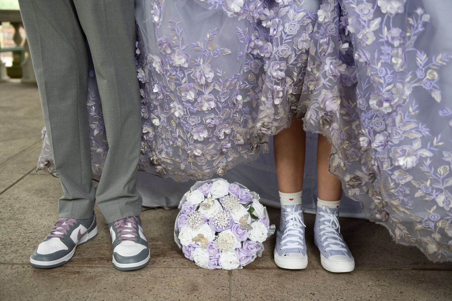 Close-up of formal shoes and dress details in lavender and gray colors.