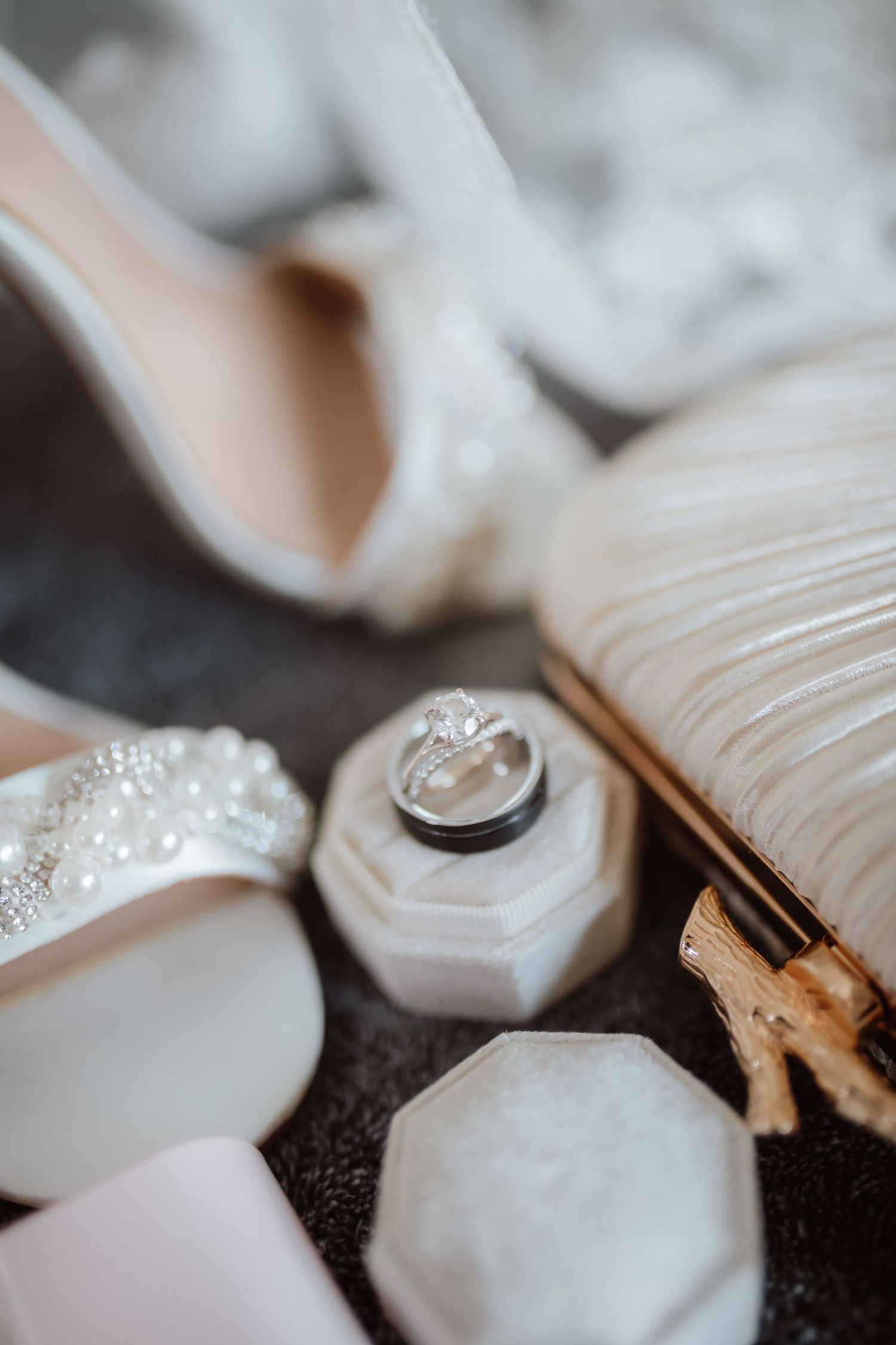 Close-up macro shots of wedding rings and delicate white fabric details.