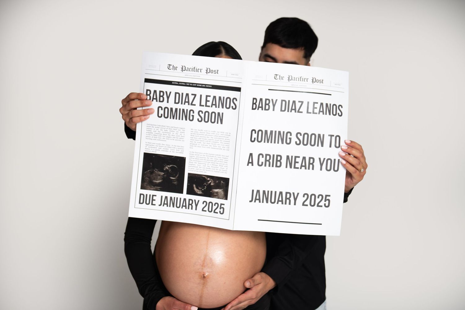 Pregnancy announcement photo with 'Coming Soon' text signs.