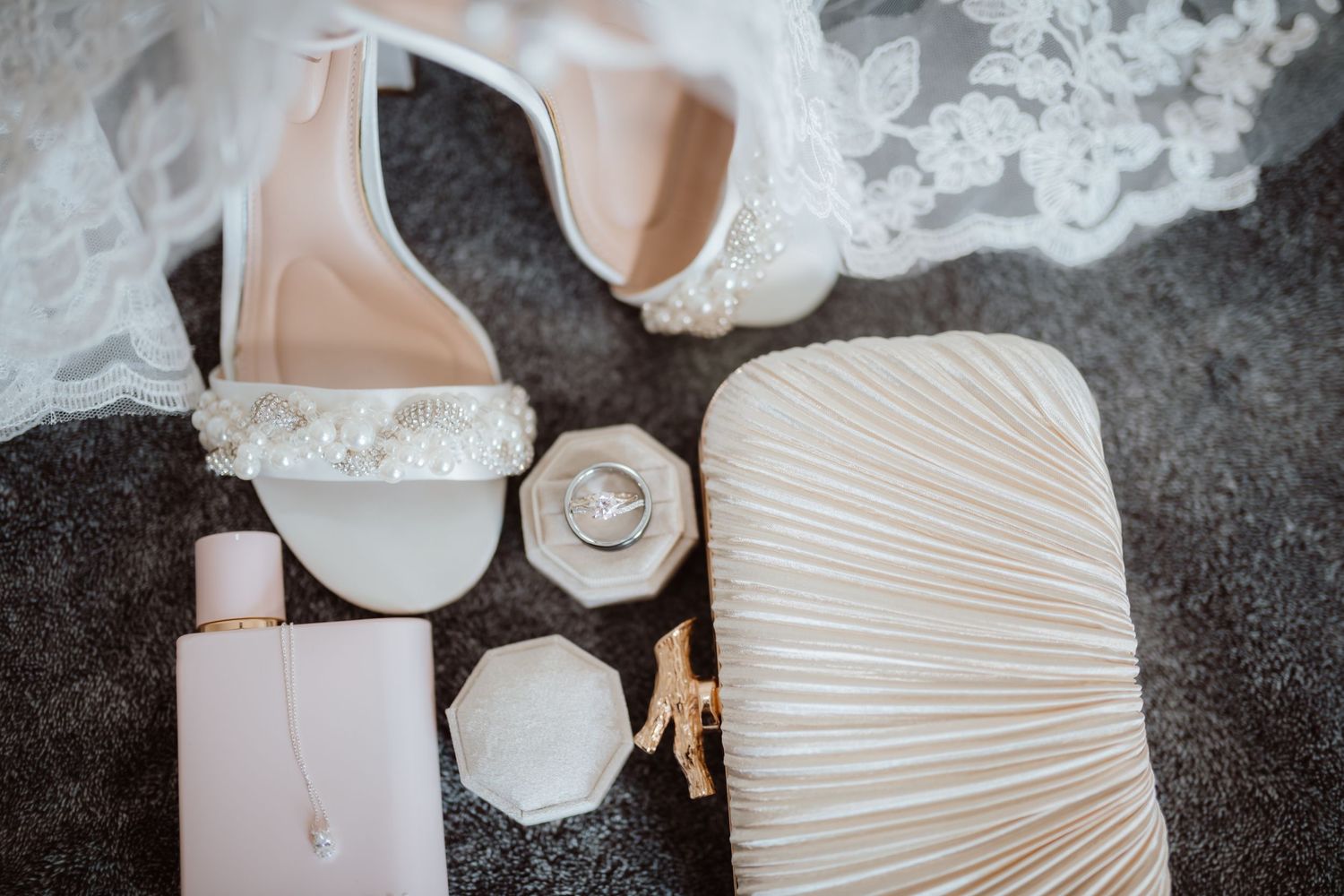 Close-up details of white wedding dress with pleated fabric textures.