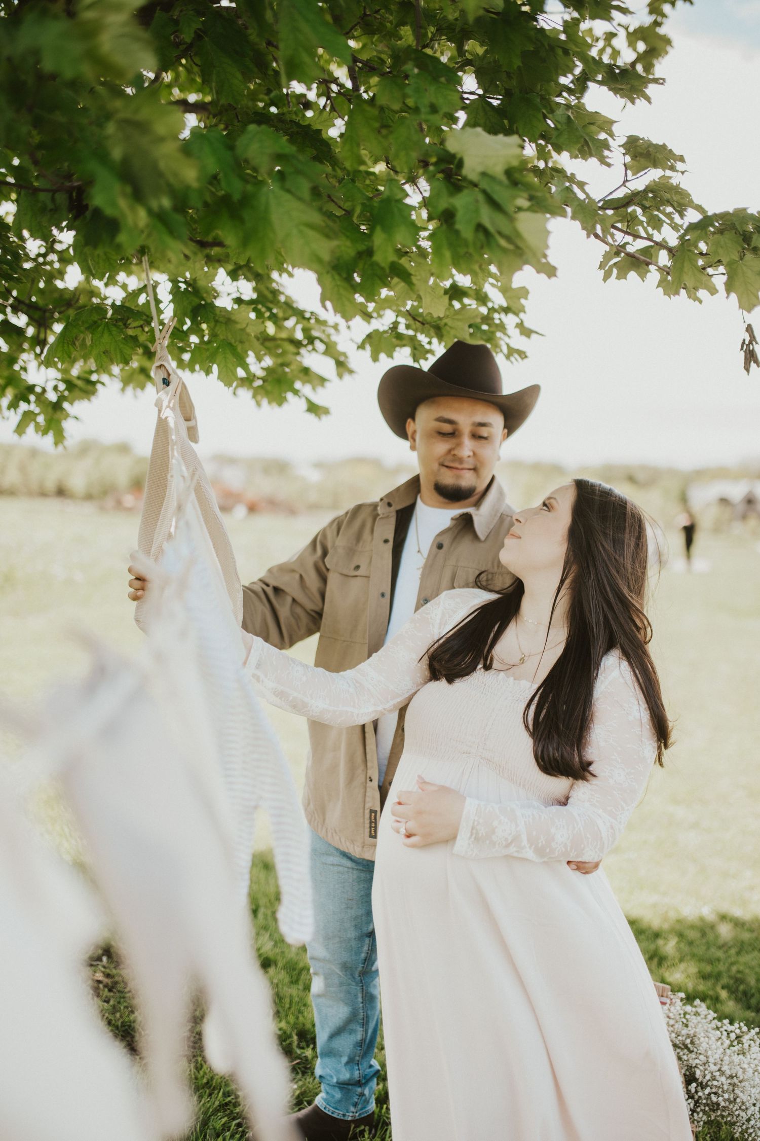 Romantic countryside photoshoot under green maple trees.