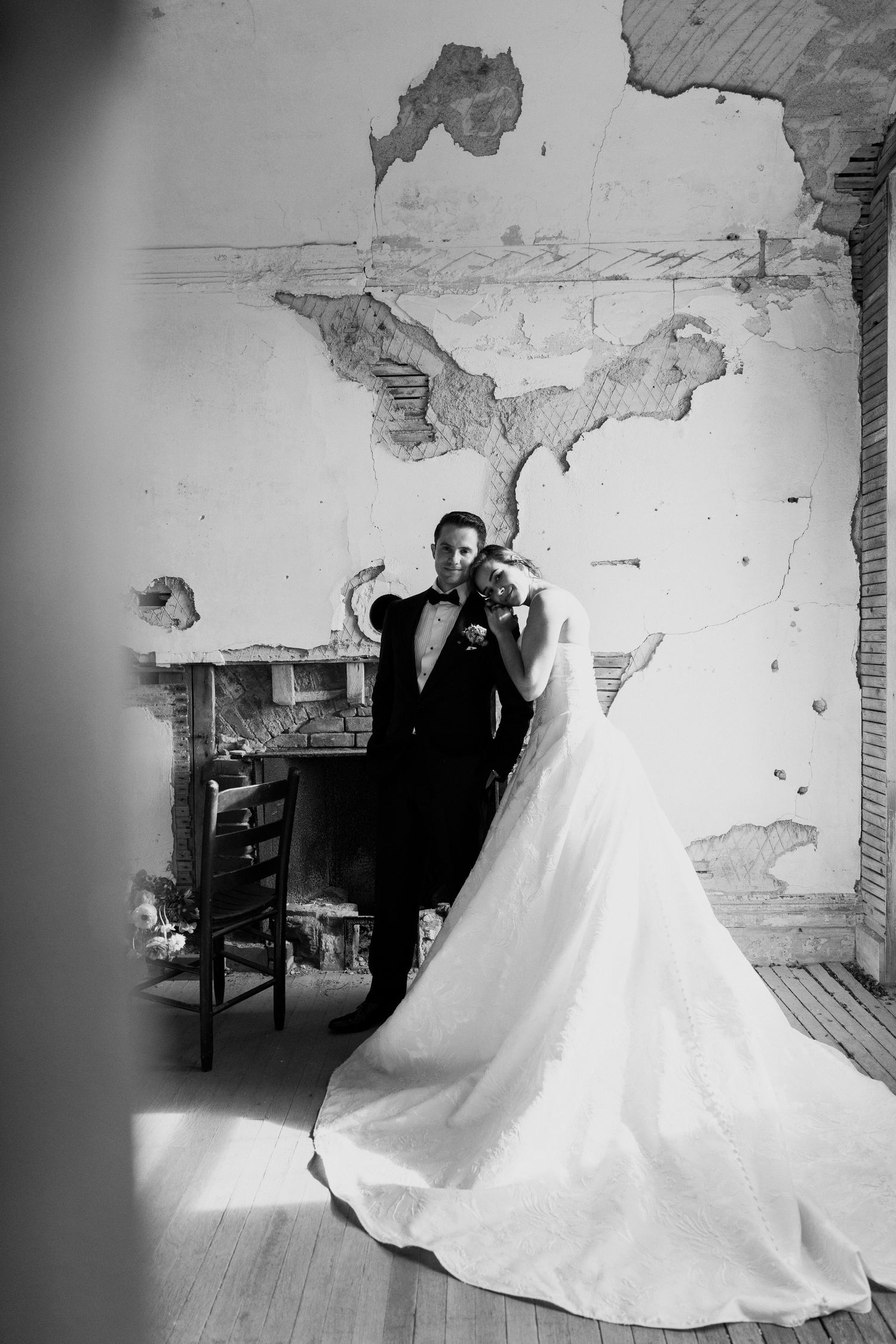 Black and white wedding photos in industrial space with dramatic dress train.