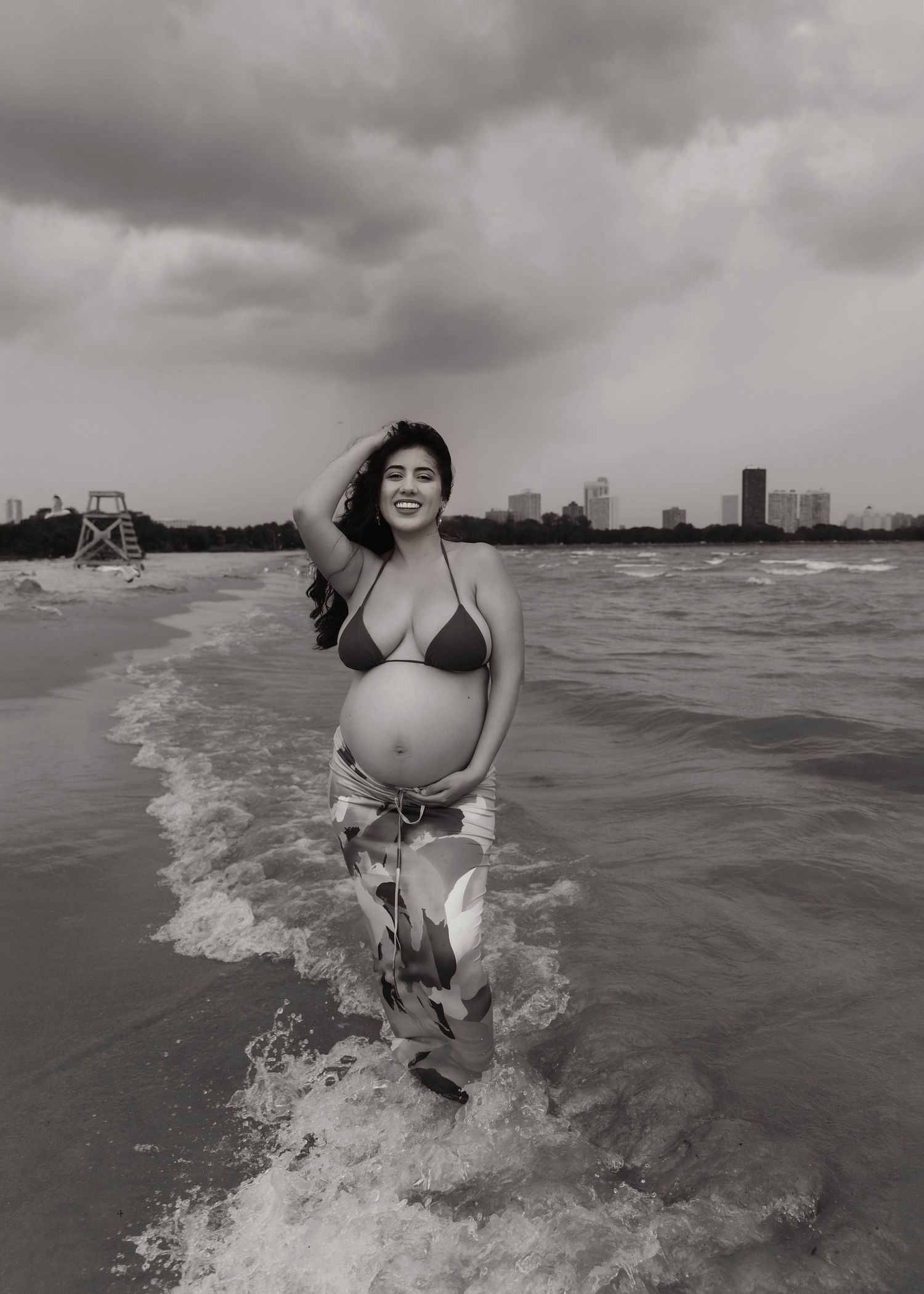 Beach Swim maternity session on overcast day on Montrose Beach in Chicago, IL