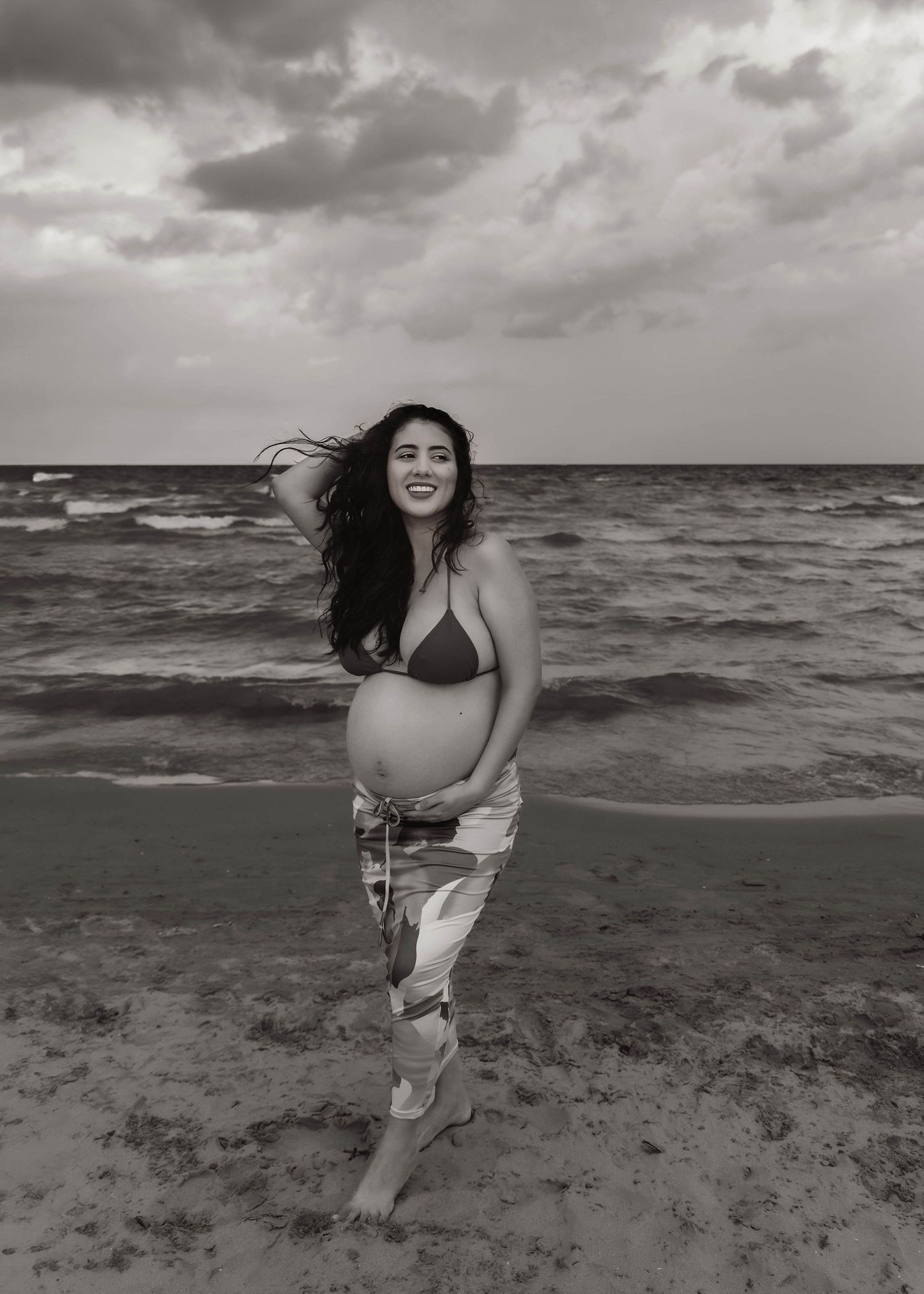 Beach Swim maternity session on overcast day on Montrose Beach in Chicago, IL