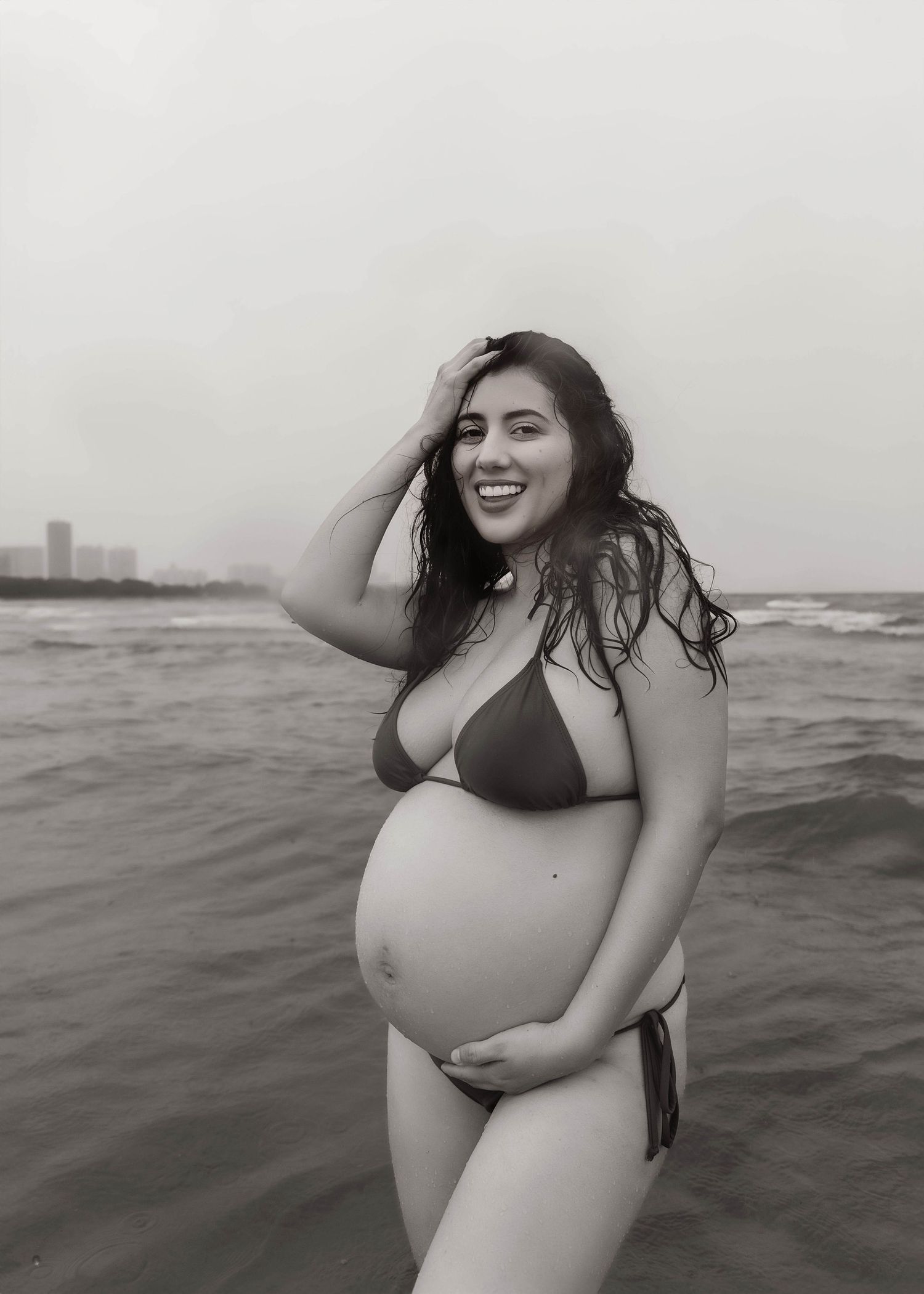 Beach Swim maternity session on overcast day on Montrose Beach in Chicago, IL