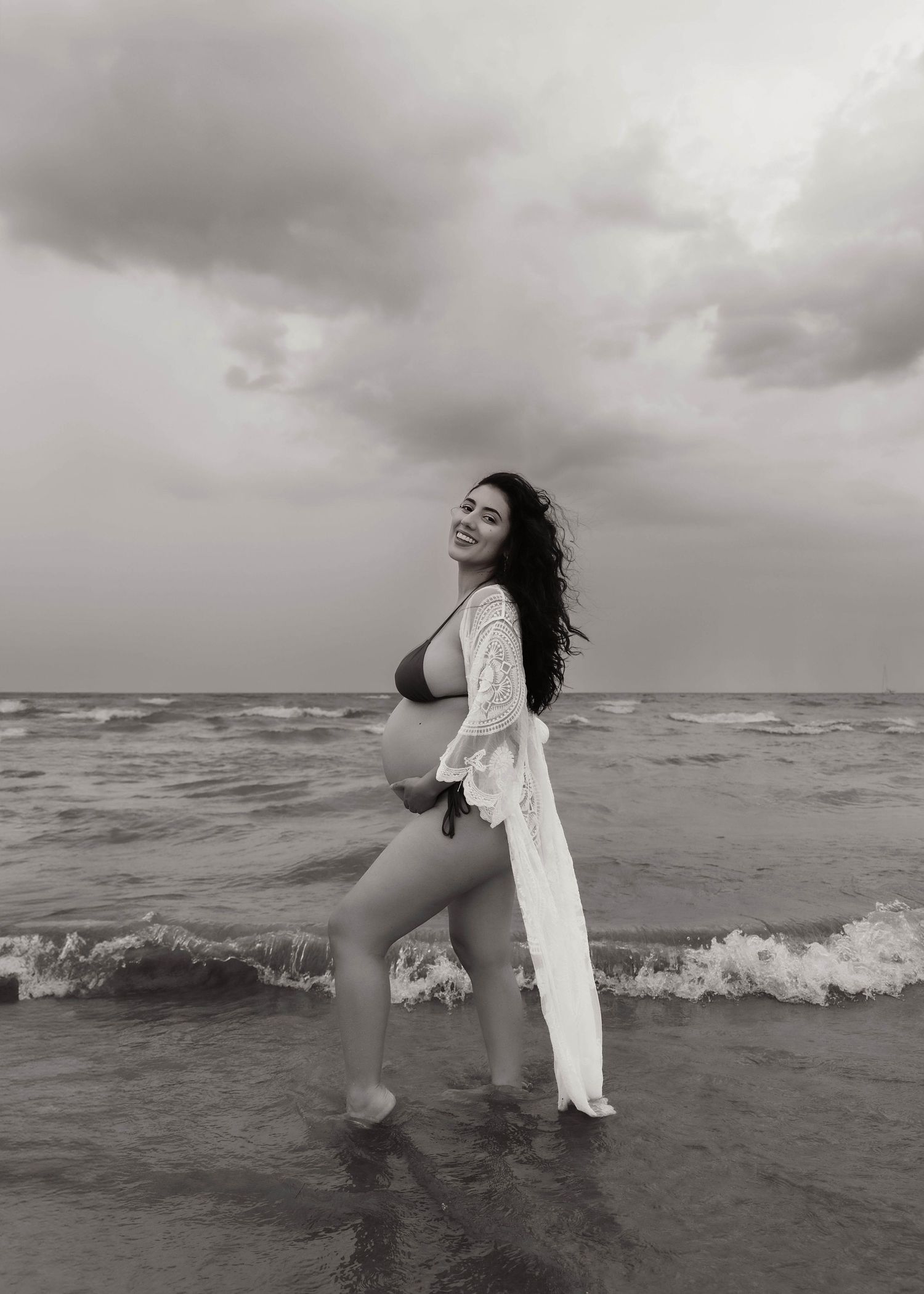 Beach Swim maternity session on overcast day on Montrose Beach in Chicago, IL