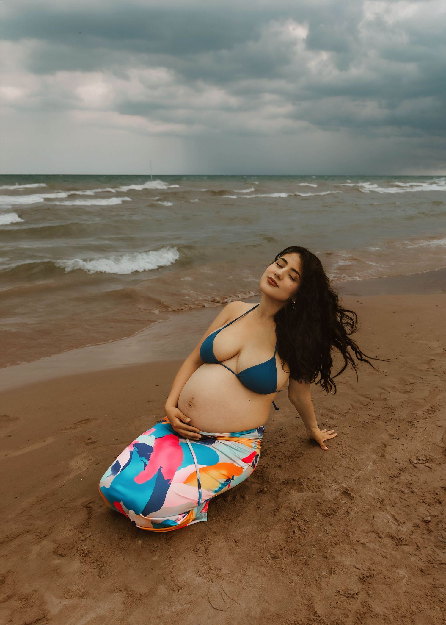 Beach Swim maternity session on overcast day on Montrose Beach in Chicago, IL