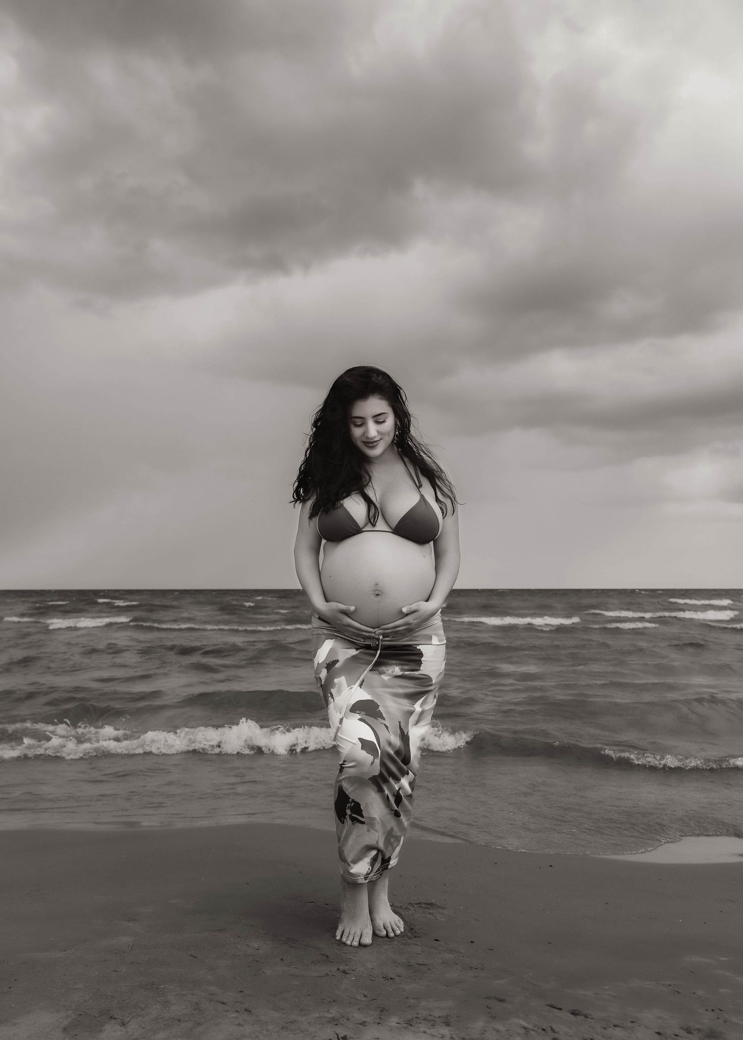 Beach Swim maternity session on overcast day on Montrose Beach in Chicago, IL