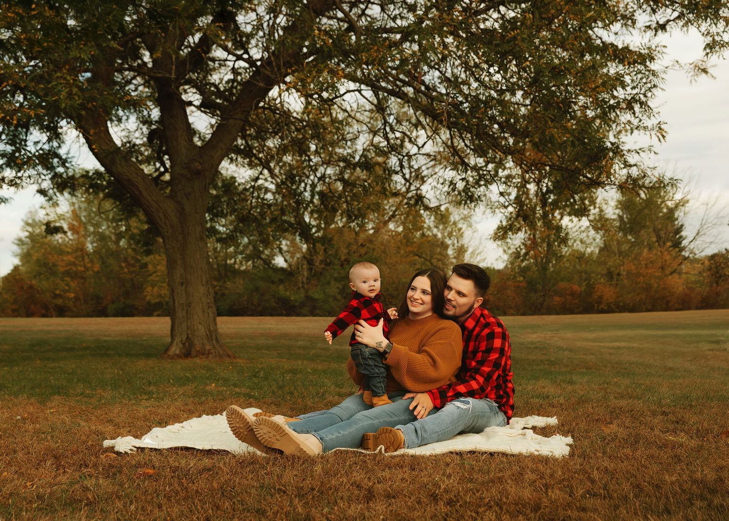 Family photo with 5 month old baby boy during fall photography session under tree at Donovan Park
