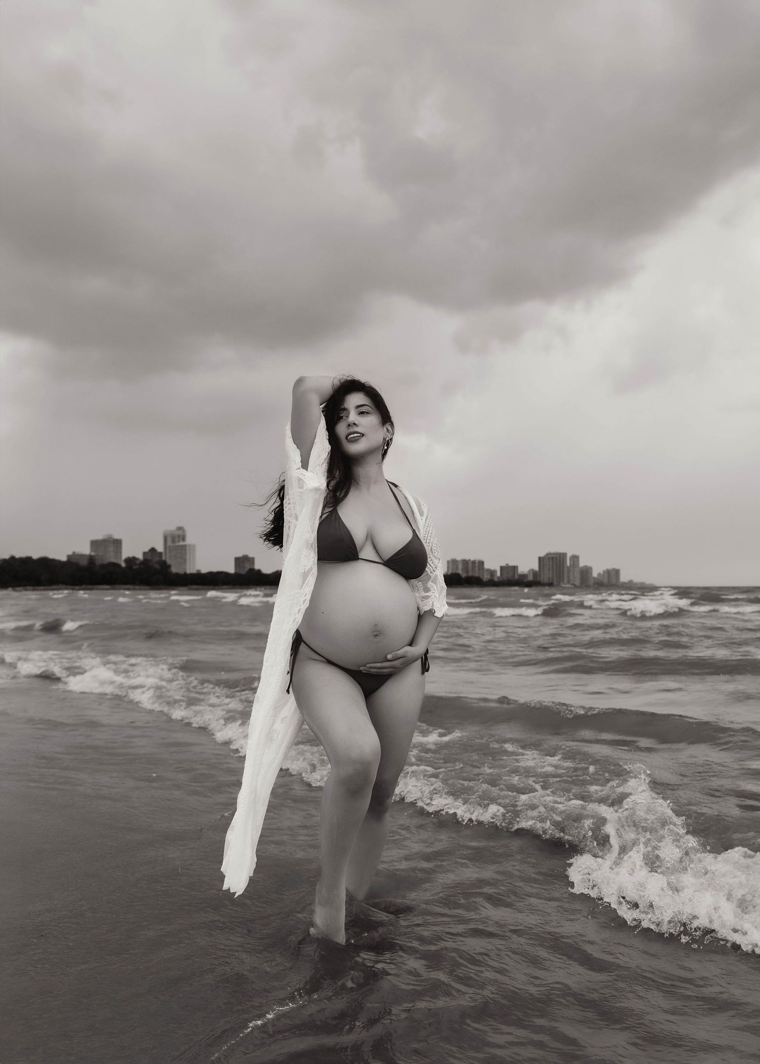 Beach Swim maternity session on overcast day on Montrose Beach in Chicago, IL