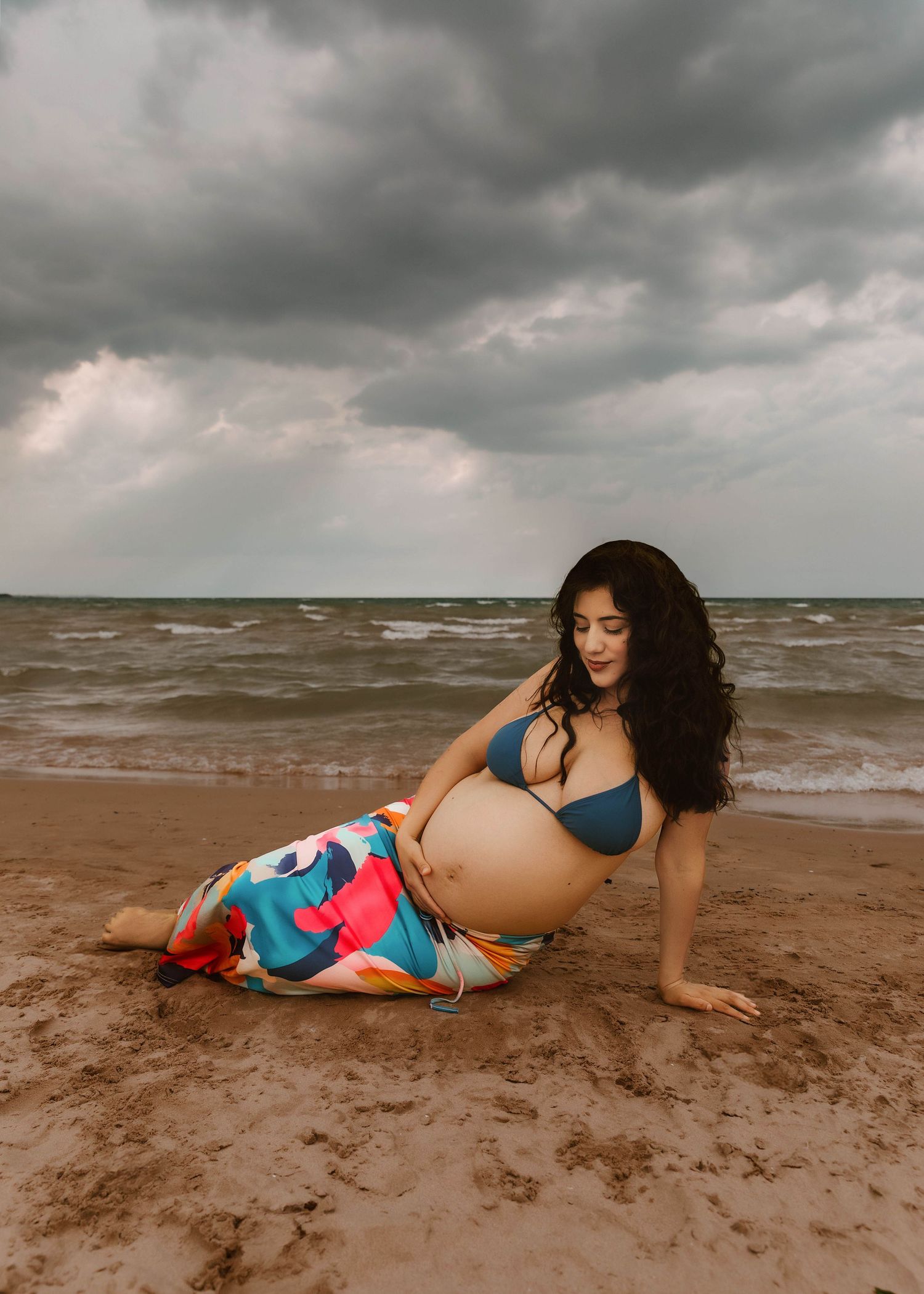 Beach Swim maternity session on overcast day on Montrose Beach in Chicago, IL