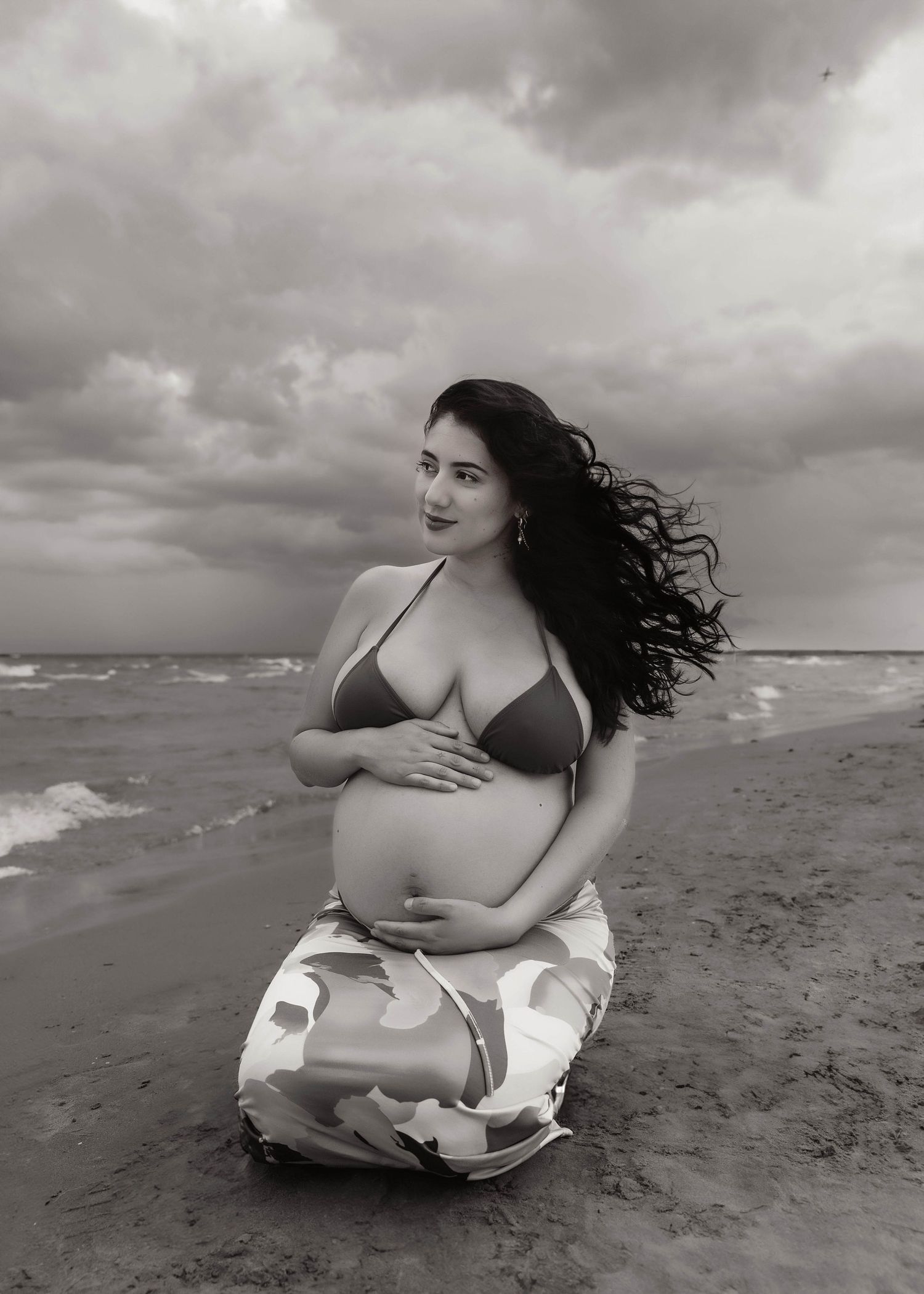 Beach Swim maternity session on overcast day on Montrose Beach in Chicago, IL