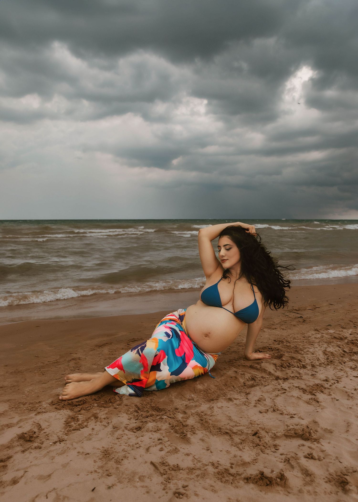 Beach Swim maternity session on overcast day on Montrose Beach in Chicago, IL
