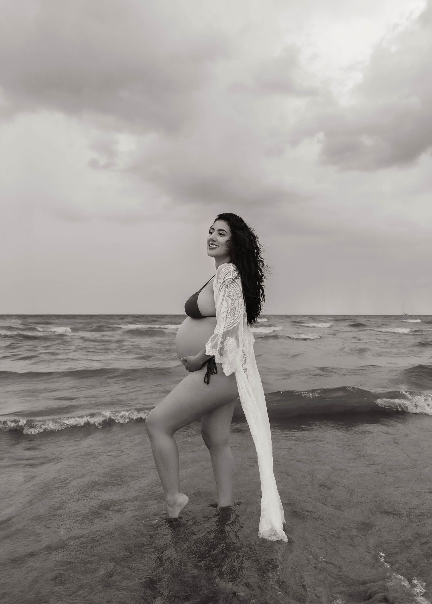 Beach Swim maternity session on overcast day on Montrose Beach in Chicago, IL