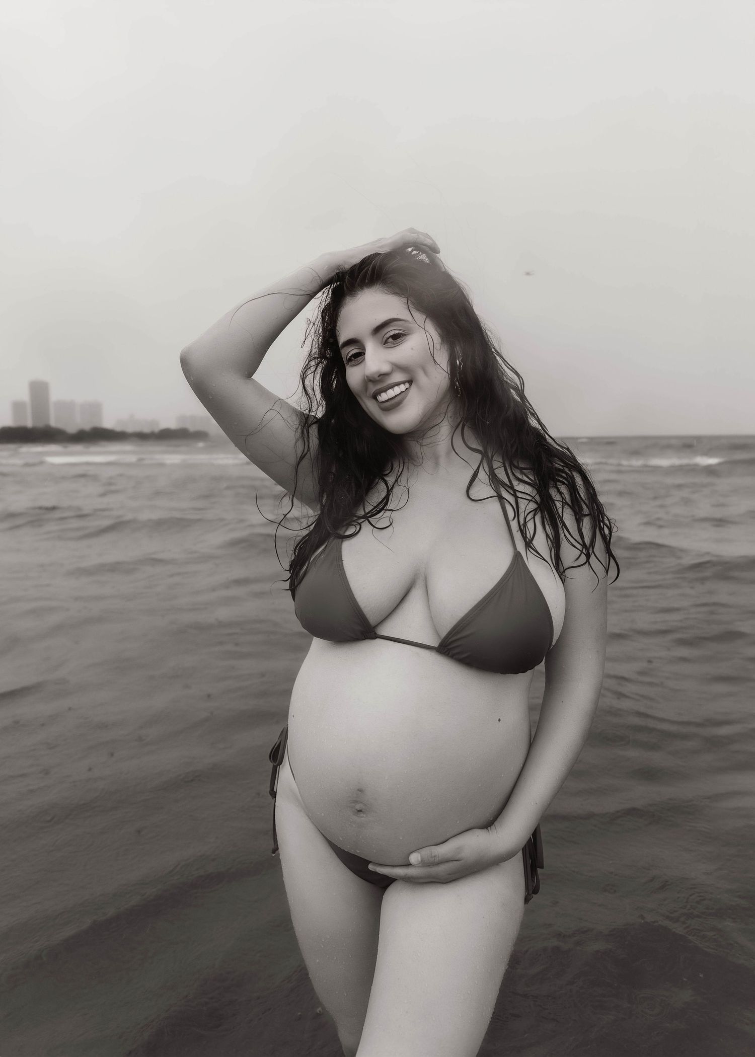 Beach Swim maternity session on overcast day on Montrose Beach in Chicago, IL
