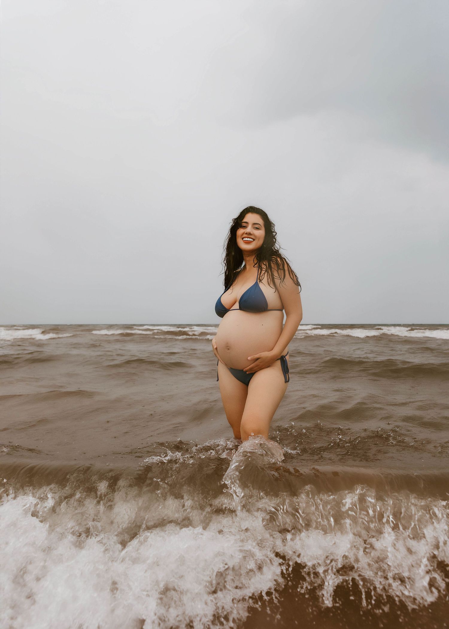 Beach Swim maternity session on overcast day on Montrose Beach in Chicago, IL