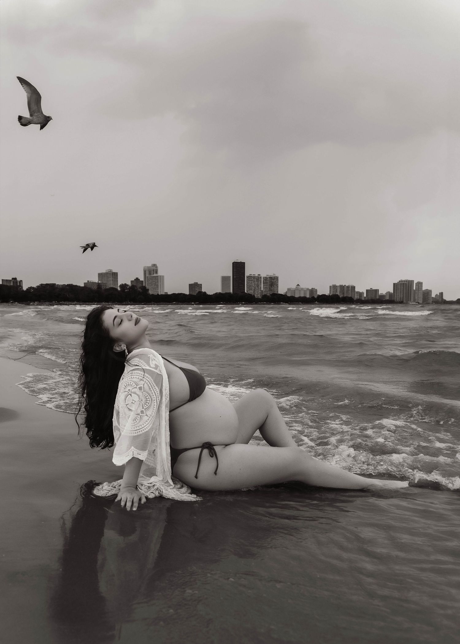 Beach Swim maternity session on overcast day on Montrose Beach in Chicago, IL