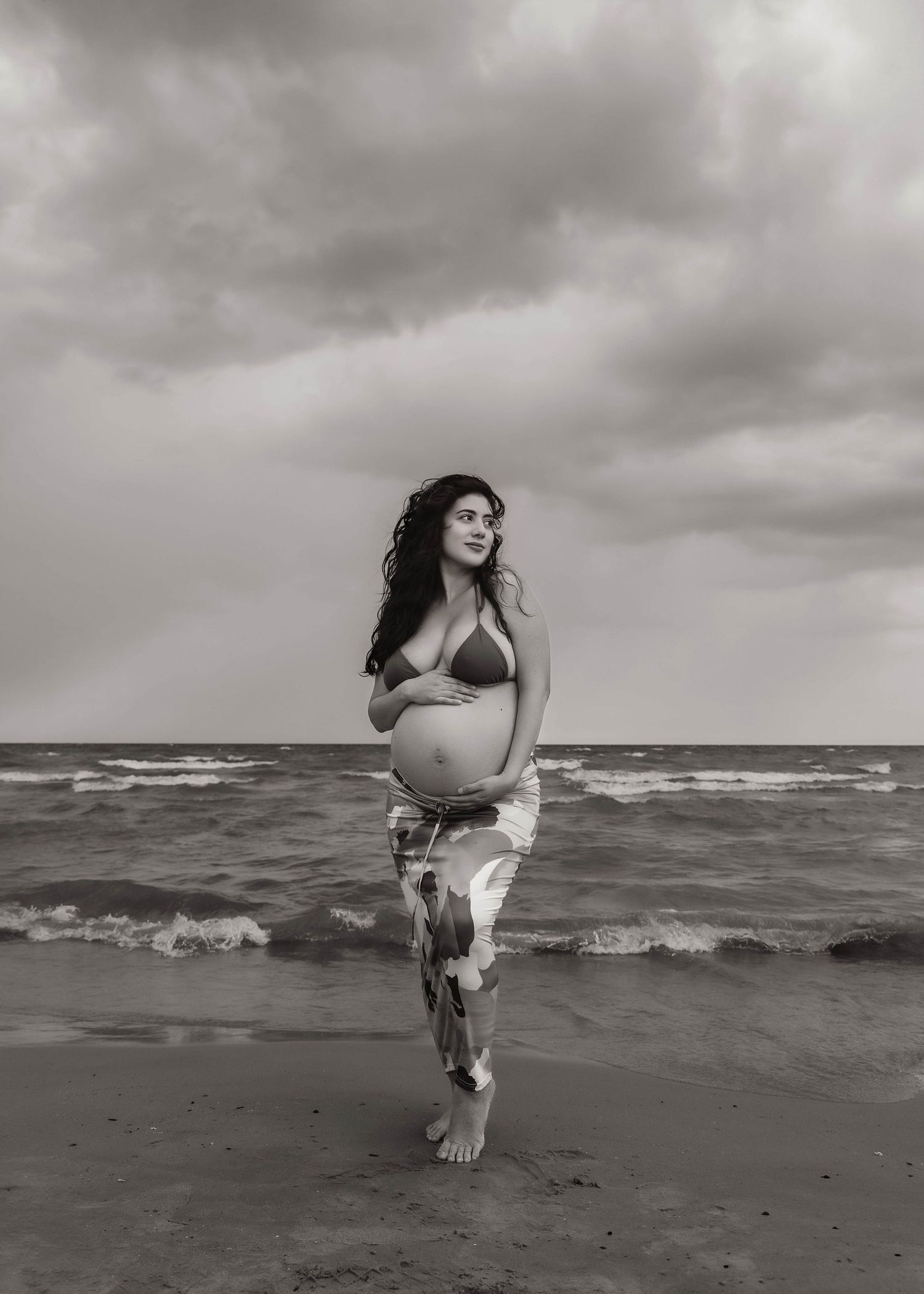Beach Swim maternity session on overcast day on Montrose Beach in Chicago, IL