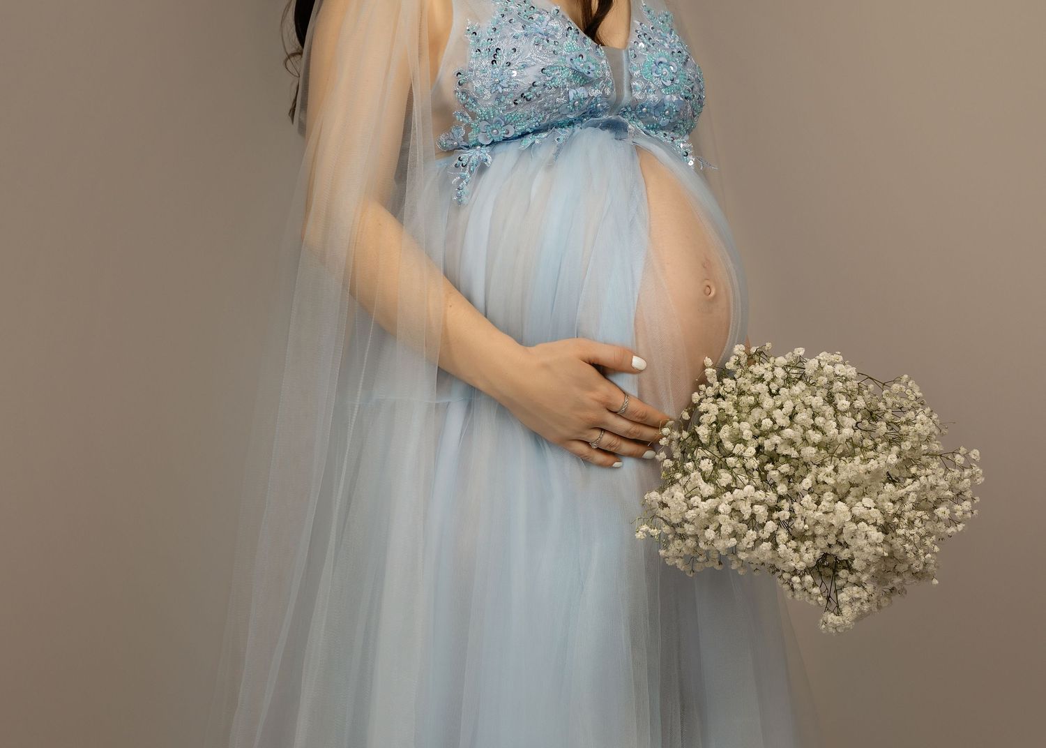 In studio maternity session with babies breath flowers expecting a baby girl