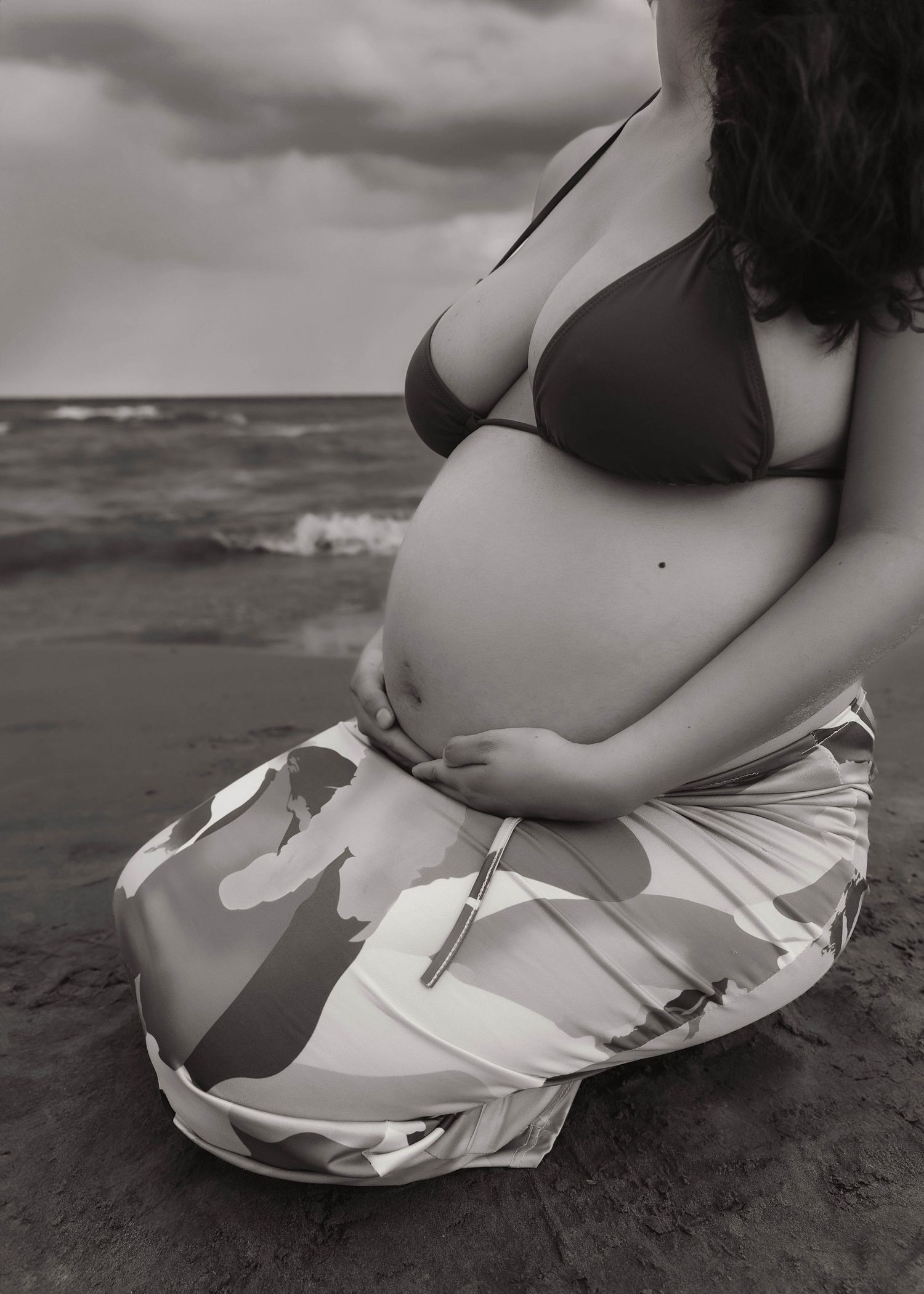 Beach Swim maternity session on overcast day on Montrose Beach in Chicago, IL