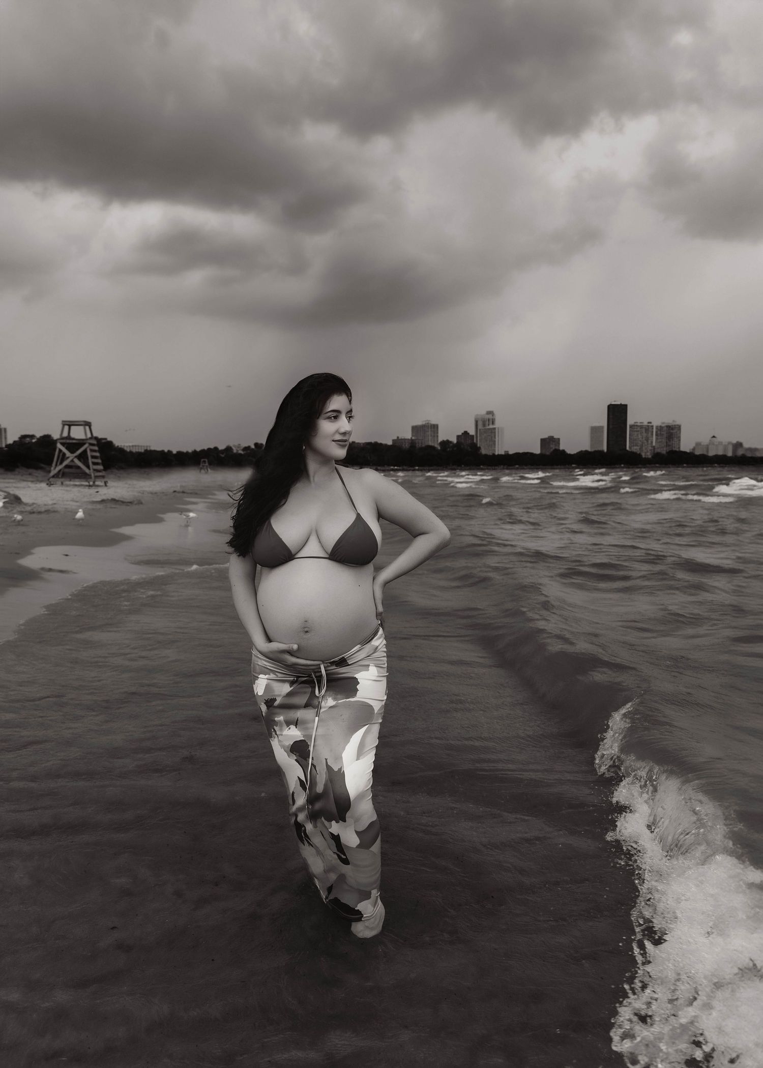 Beach Swim maternity session on overcast day on Montrose Beach in Chicago, IL