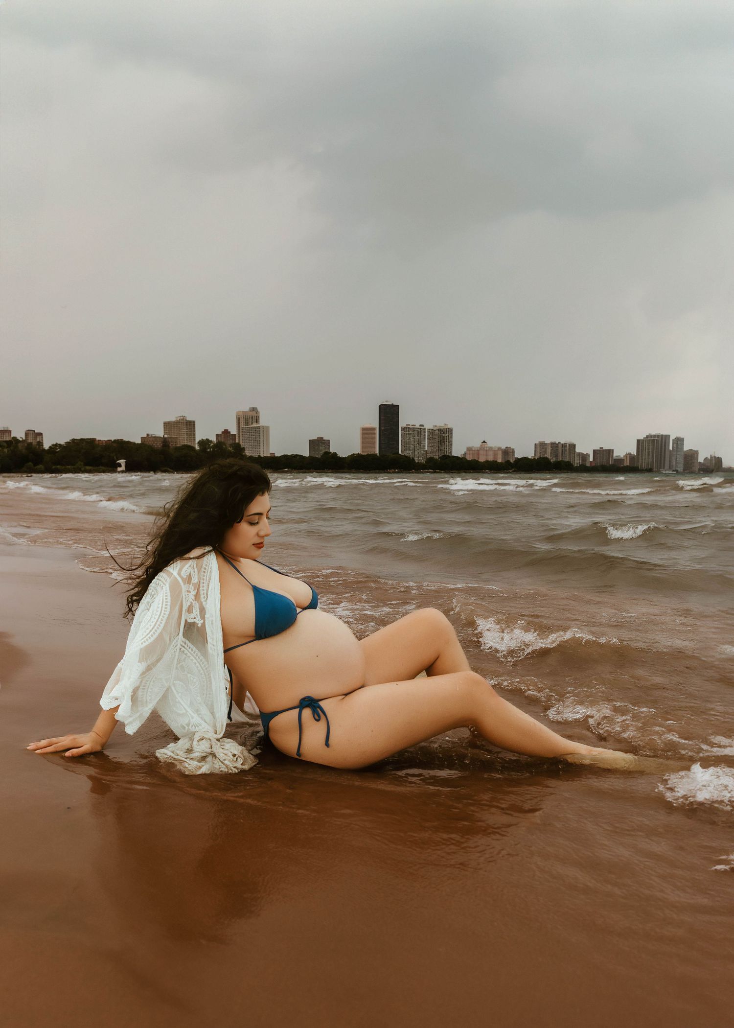 Beach Swim maternity session on overcast day on Montrose Beach in Chicago, IL