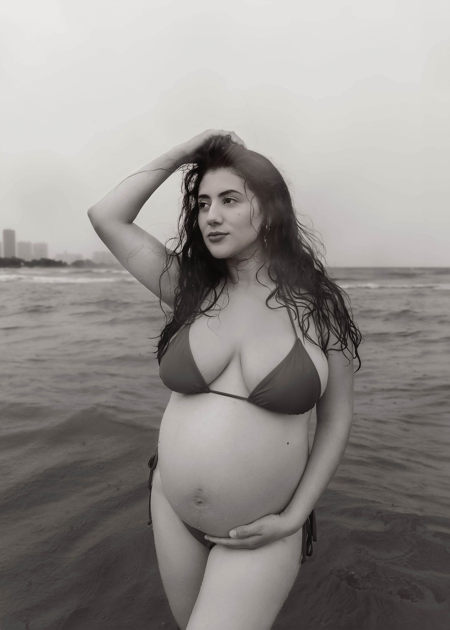 Beach Swim maternity session on overcast day on Montrose Beach in Chicago, IL