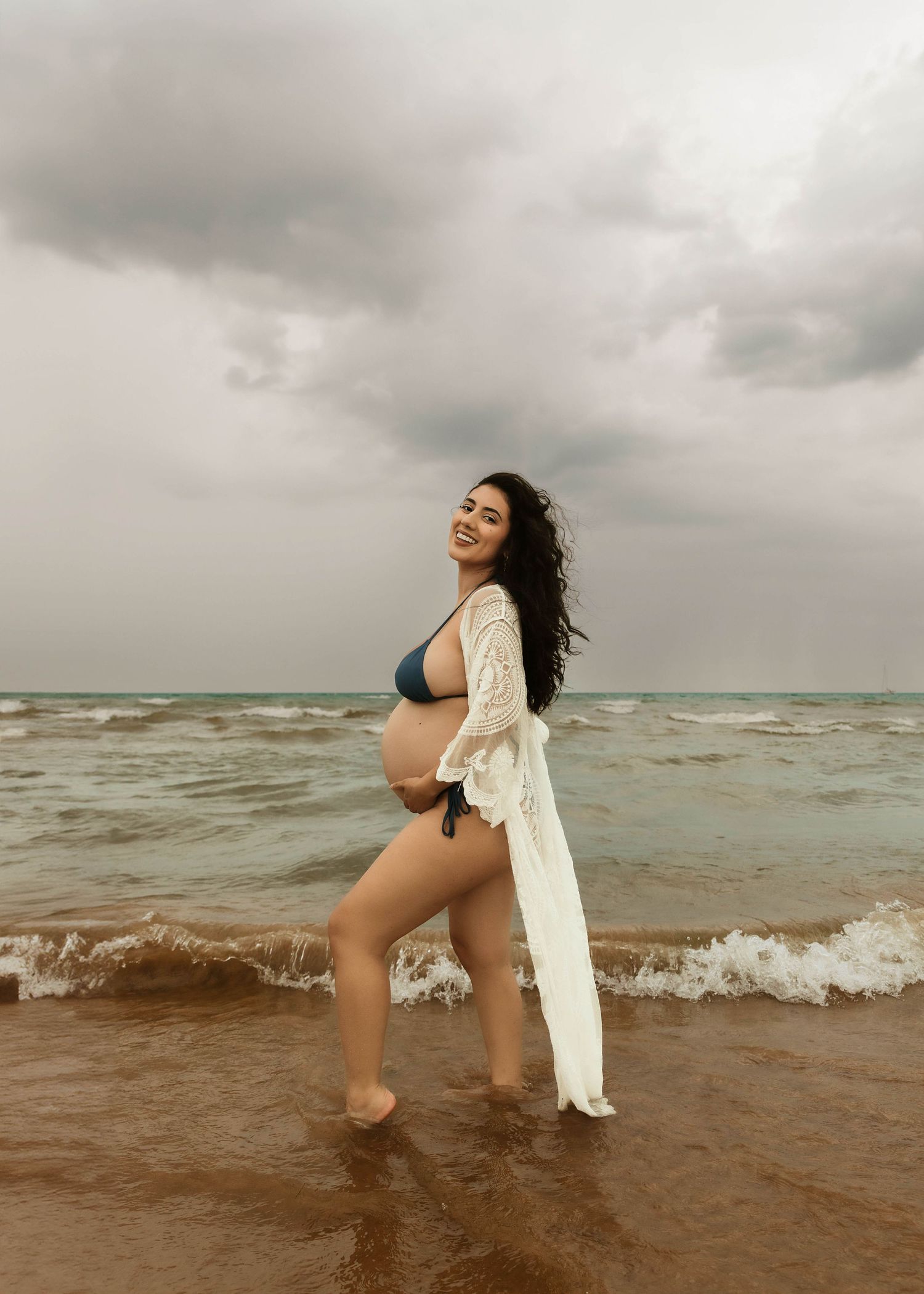 Beach Swim maternity session on overcast day on Montrose Beach in Chicago, IL
