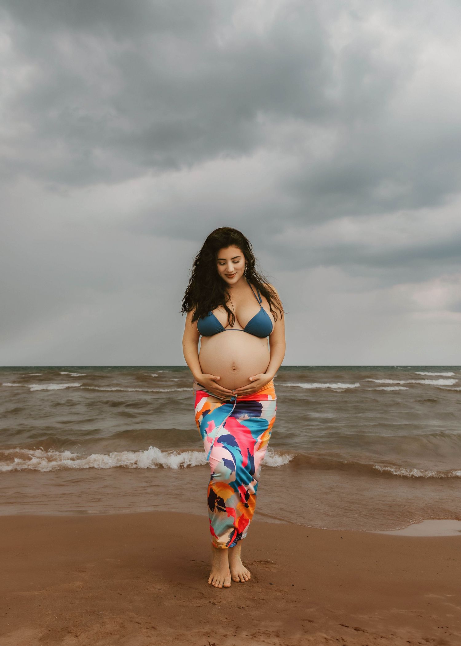 Beach Swim maternity session on overcast day on Montrose Beach in Chicago, IL