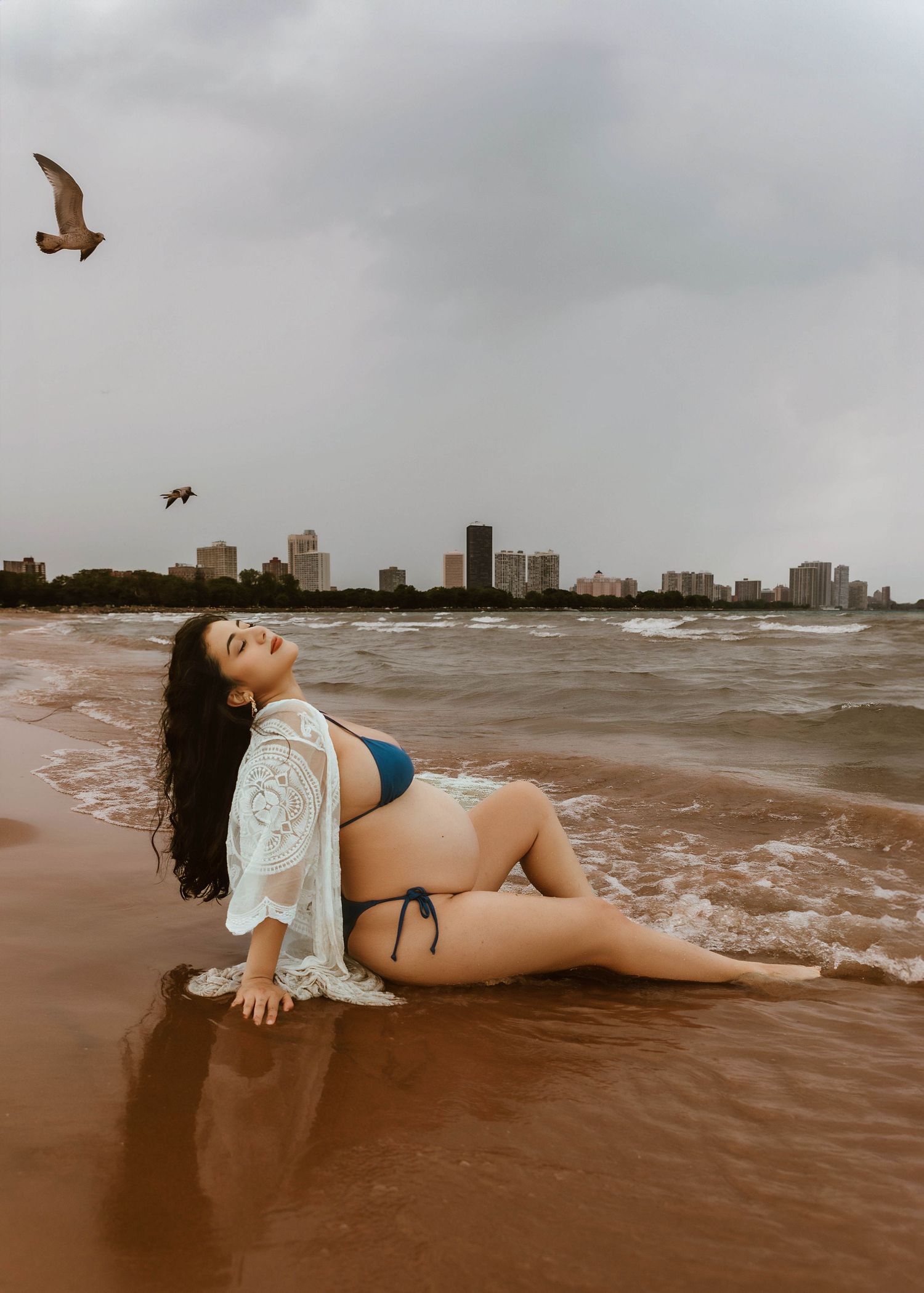 Beach Swim maternity session on overcast day on Montrose Beach in Chicago, IL