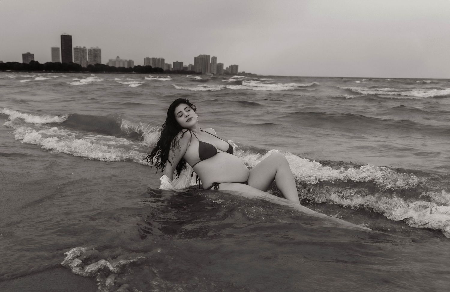 Beach Swim maternity session on overcast day on Montrose Beach in Chicago, IL