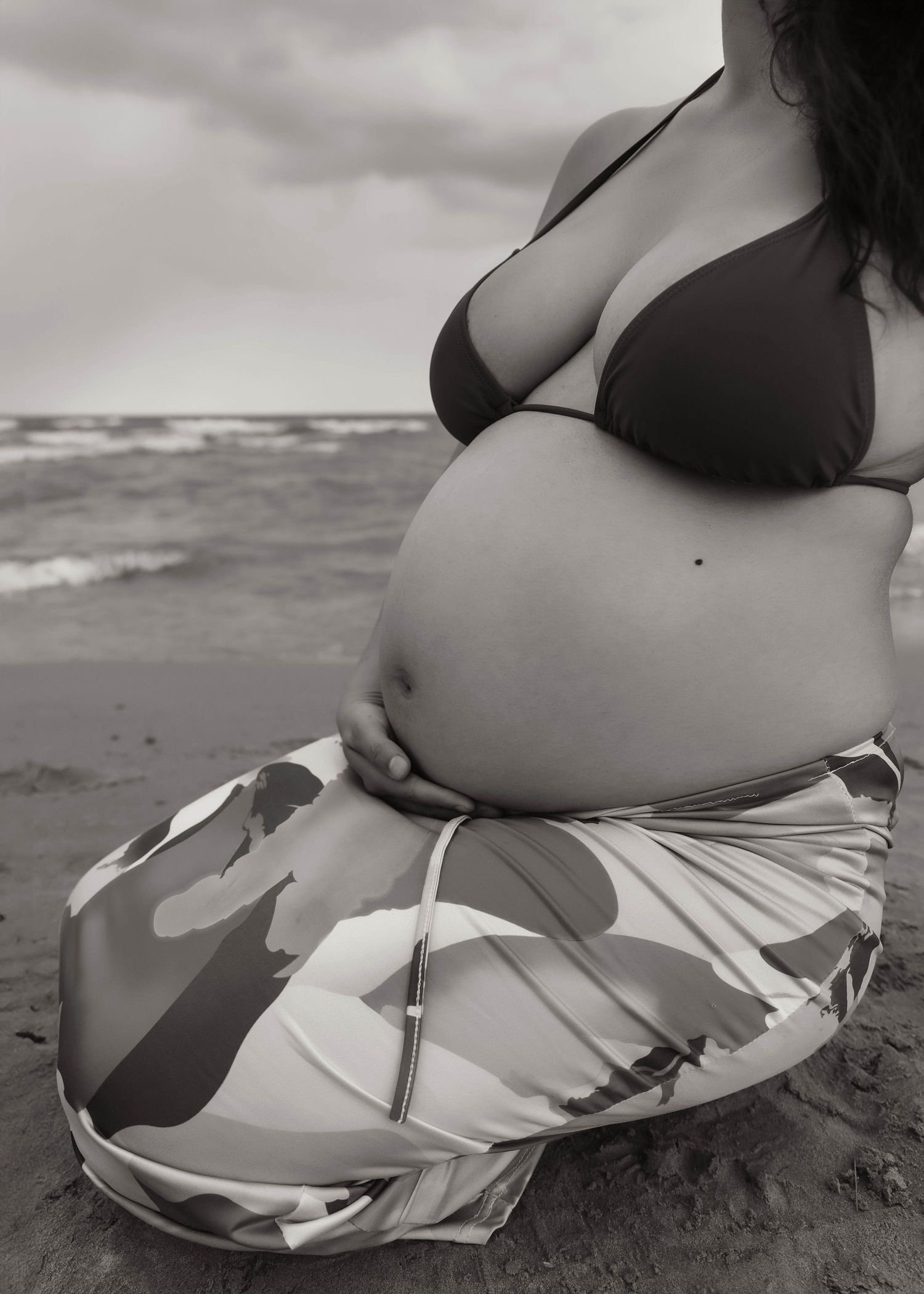 Beach Swim maternity session on overcast day on Montrose Beach in Chicago, IL