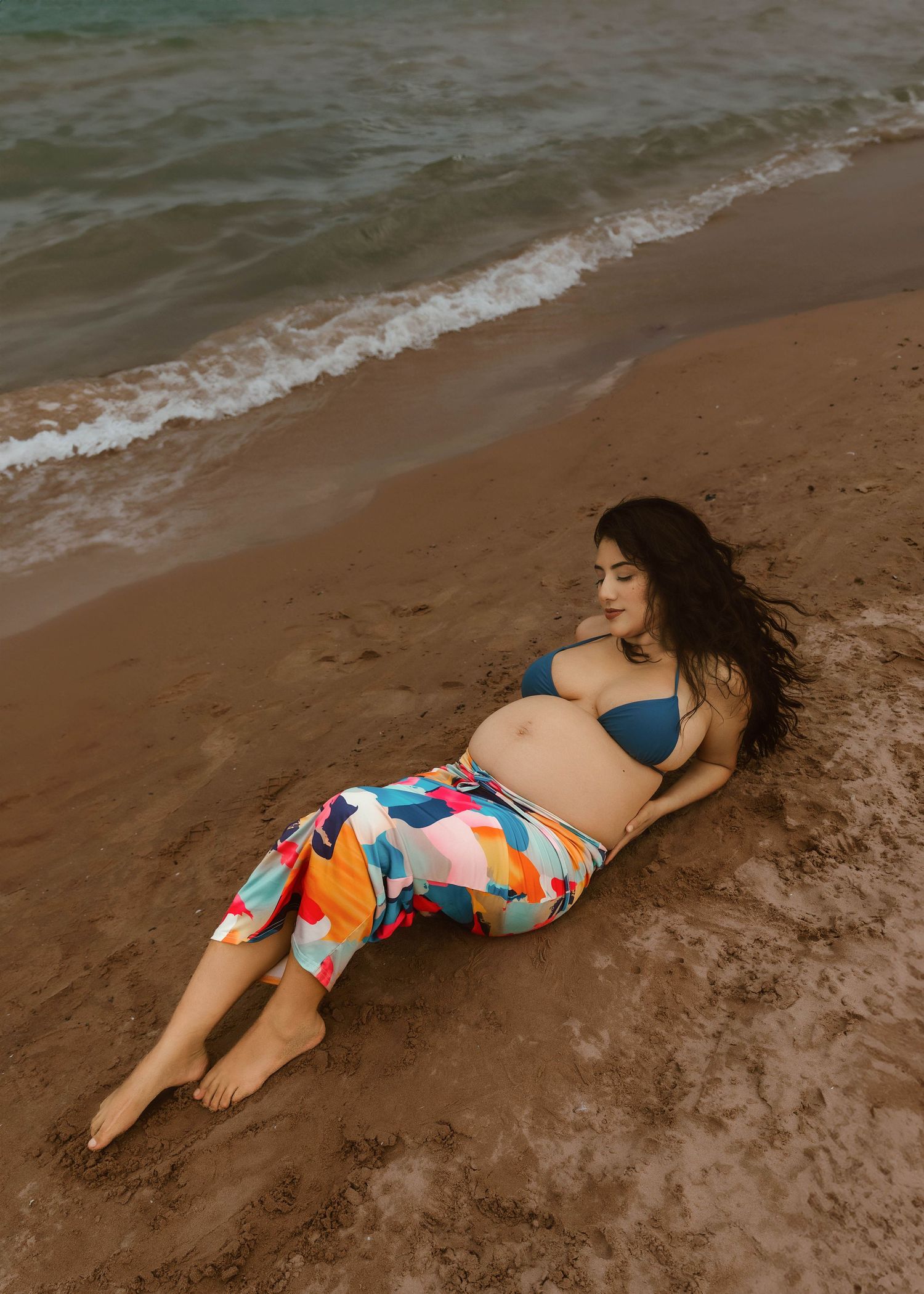 Beach Swim maternity session on overcast day on Montrose Beach in Chicago, IL
