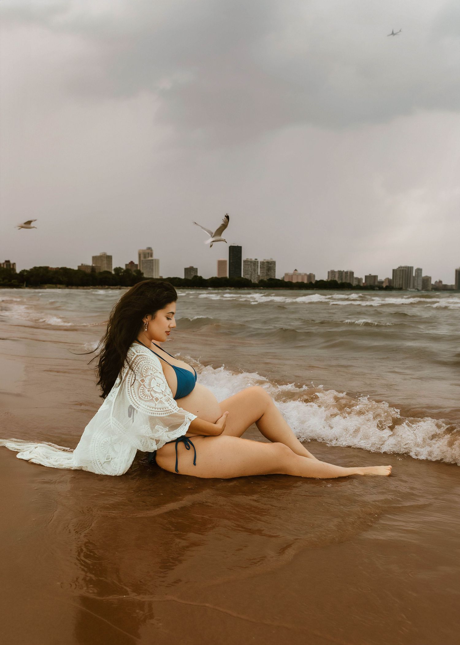 Beach Swim maternity session on overcast day on Montrose Beach in Chicago, IL