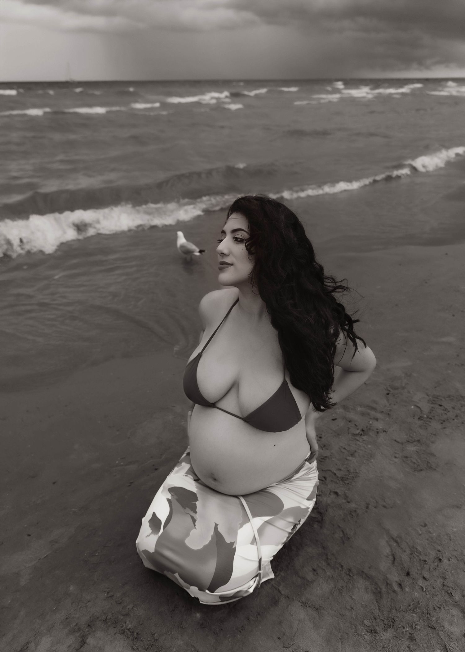 Beach Swim maternity session on overcast day on Montrose Beach in Chicago, IL