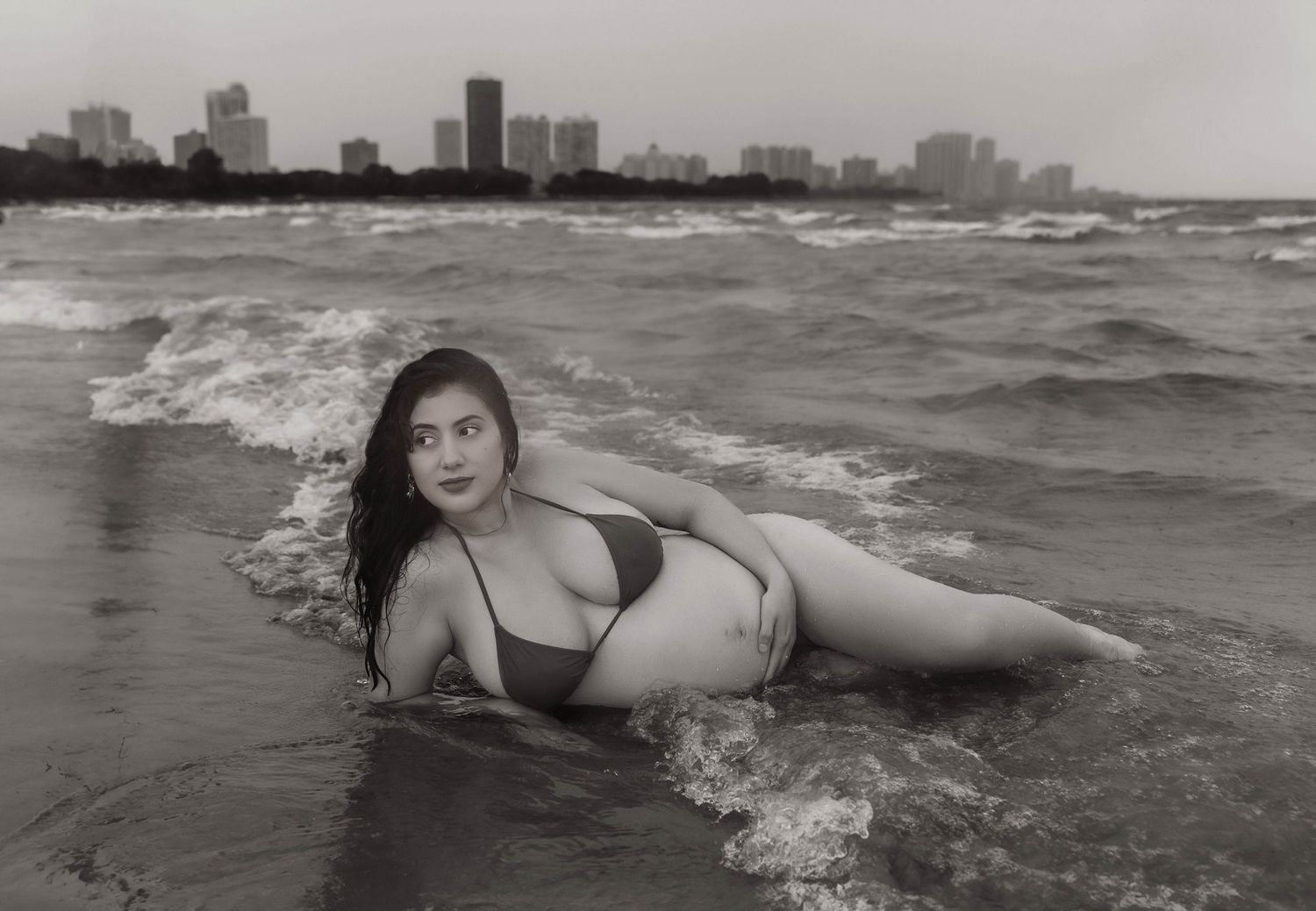 Beach Swim maternity session on overcast day on Montrose Beach in Chicago, IL