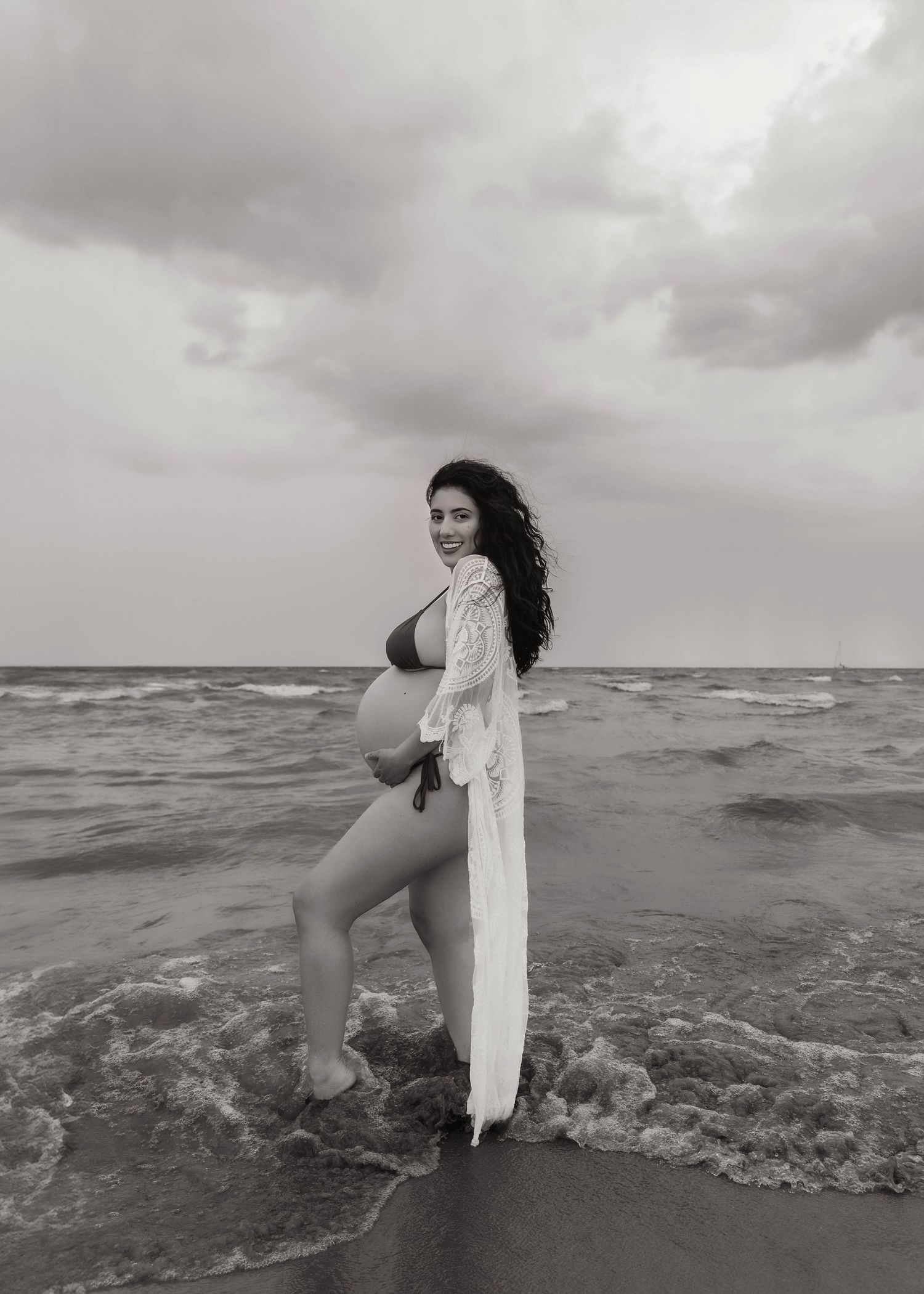 Beach Swim maternity session on overcast day on Montrose Beach in Chicago, IL