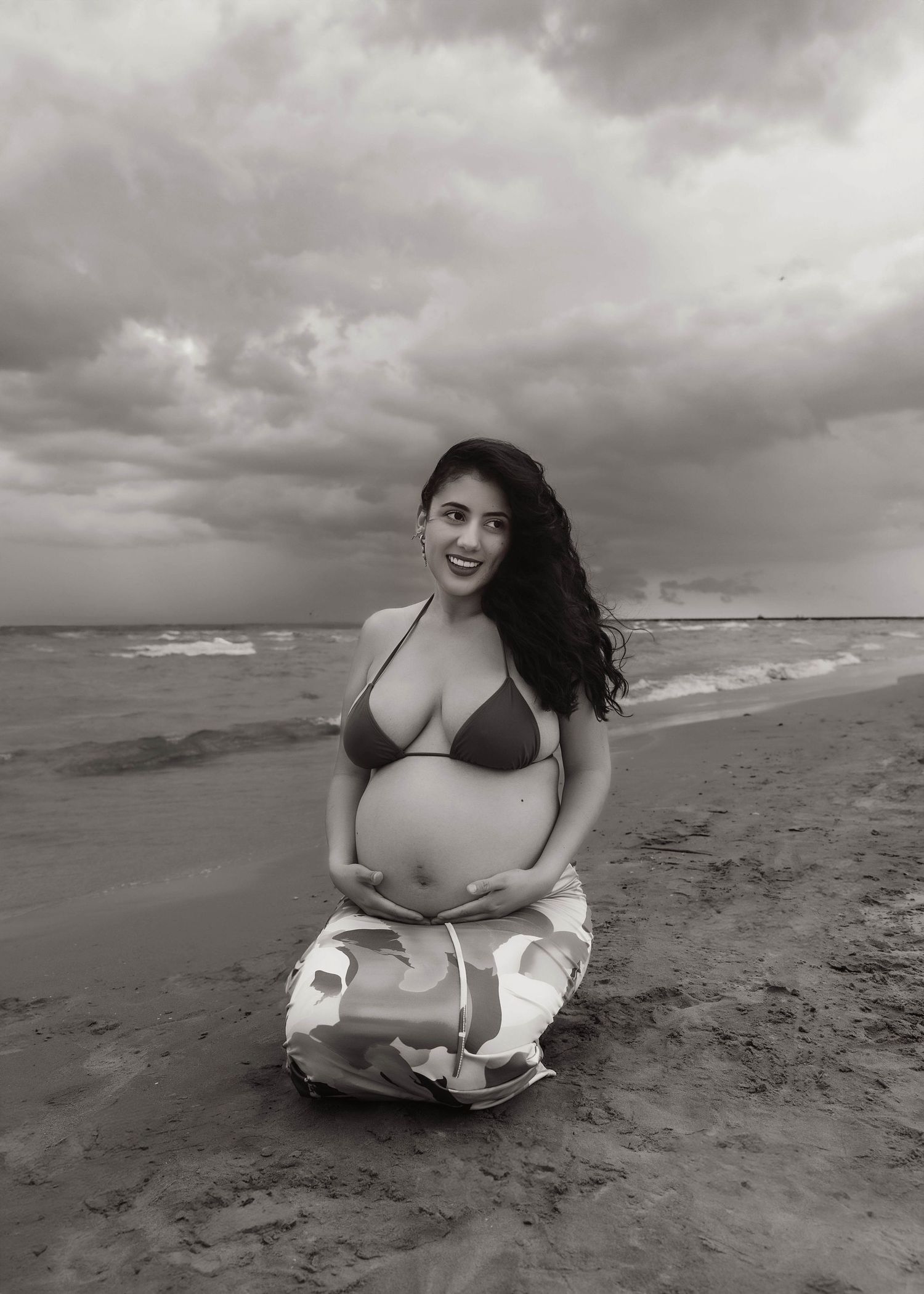 Beach Swim maternity session on overcast day on Montrose Beach in Chicago, IL