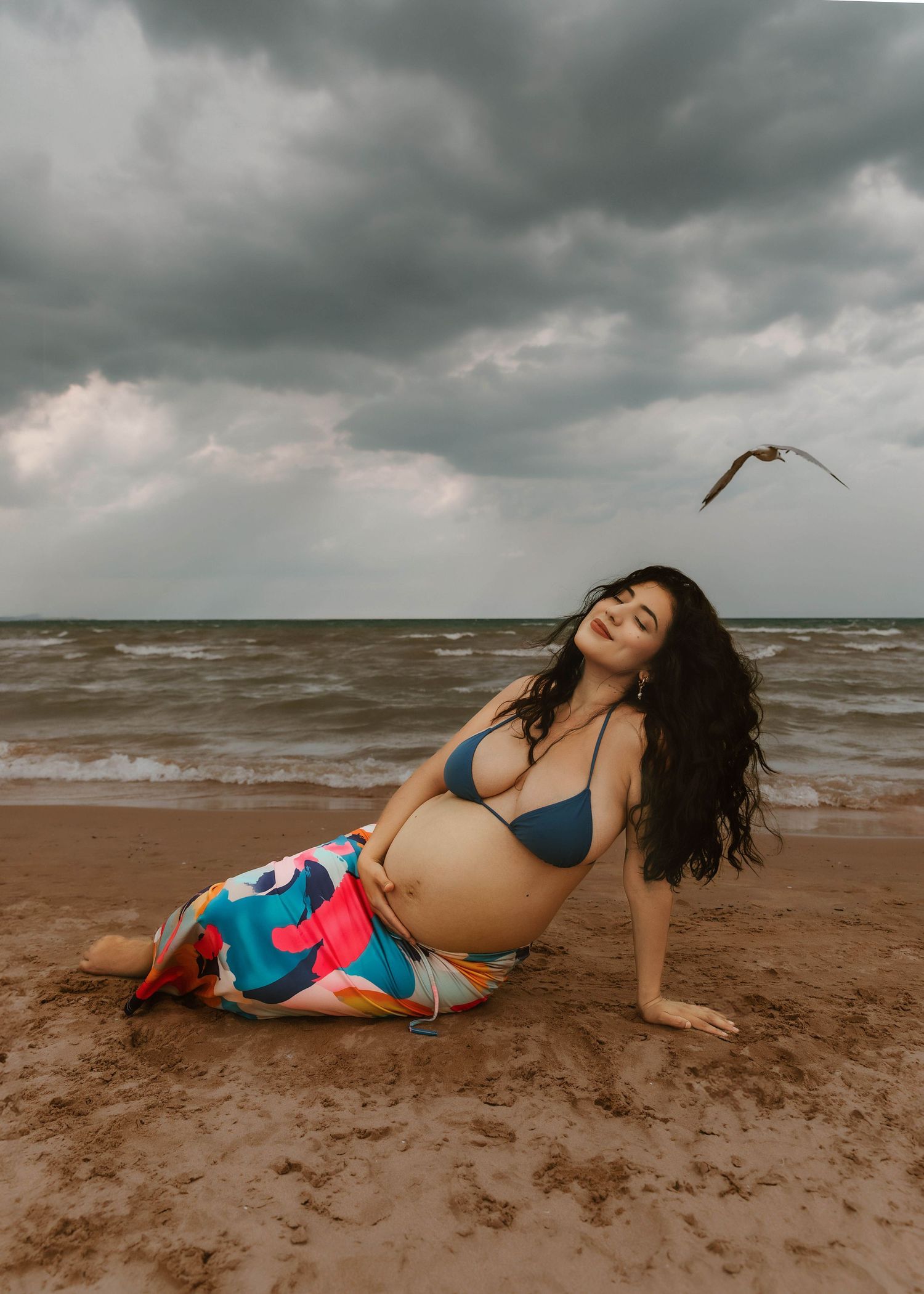 Beach Swim maternity session on overcast day on Montrose Beach in Chicago, IL