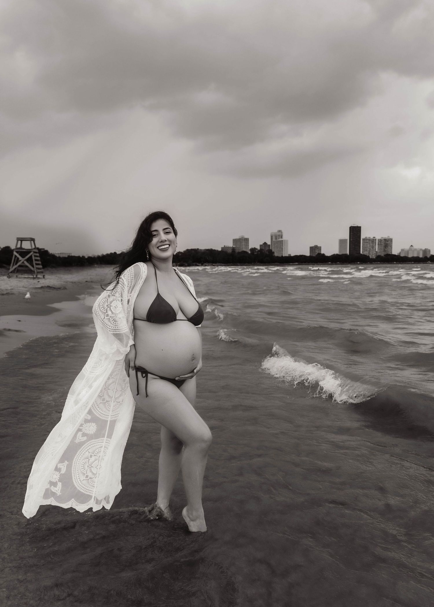 Beach Swim maternity session on overcast day on Montrose Beach in Chicago, IL