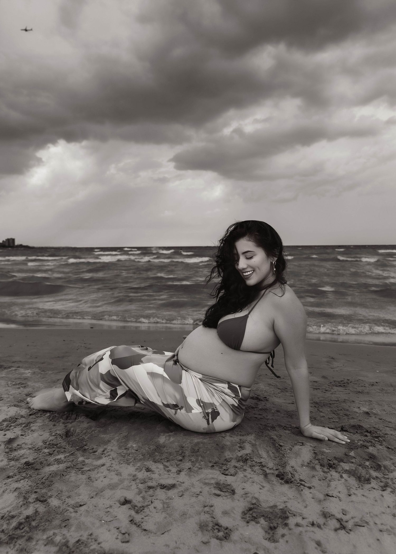 Beach Swim maternity session on overcast day on Montrose Beach in Chicago, IL