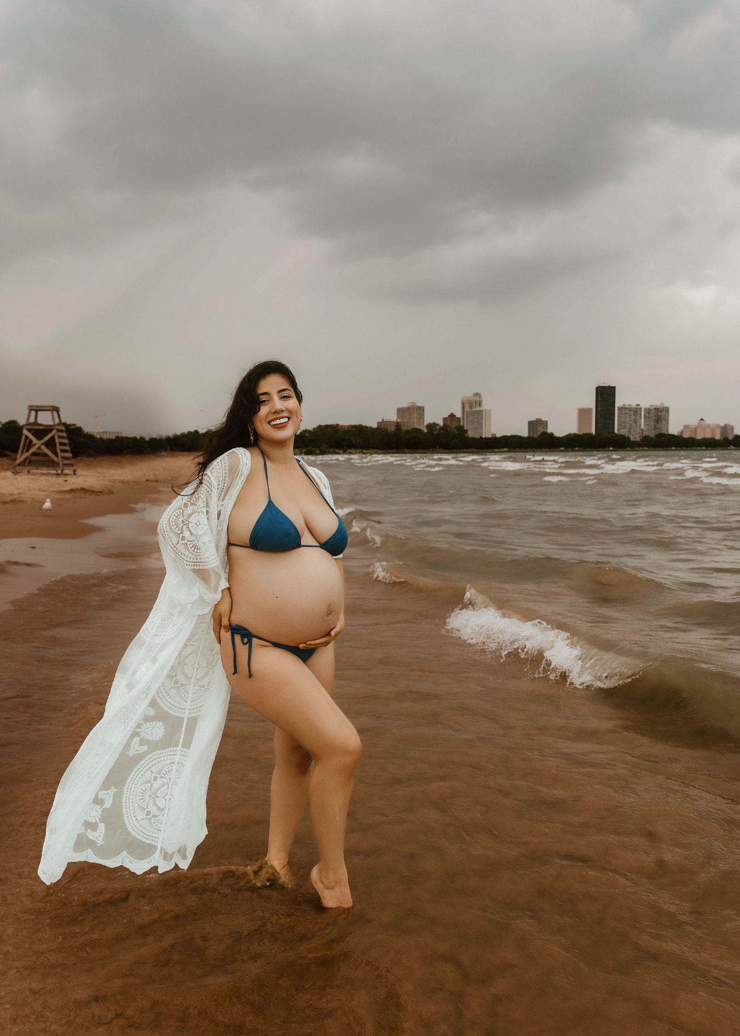 Beach Swim maternity session on overcast day on Montrose Beach in Chicago, IL