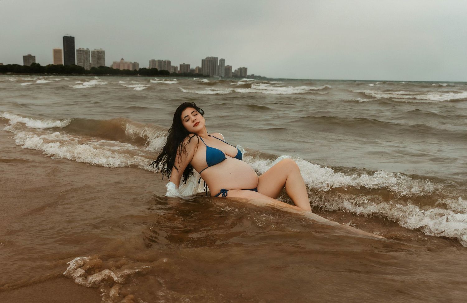 Beach Swim maternity session on overcast day on Montrose Beach in Chicago, IL