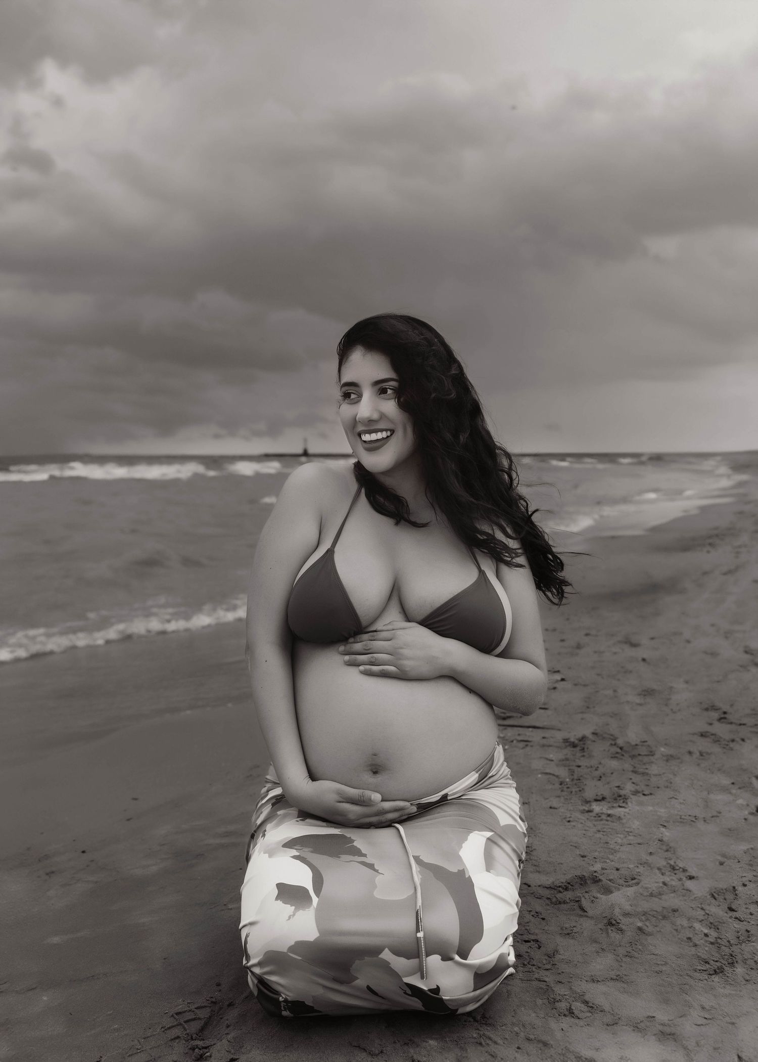 Beach Swim maternity session on overcast day on Montrose Beach in Chicago, IL