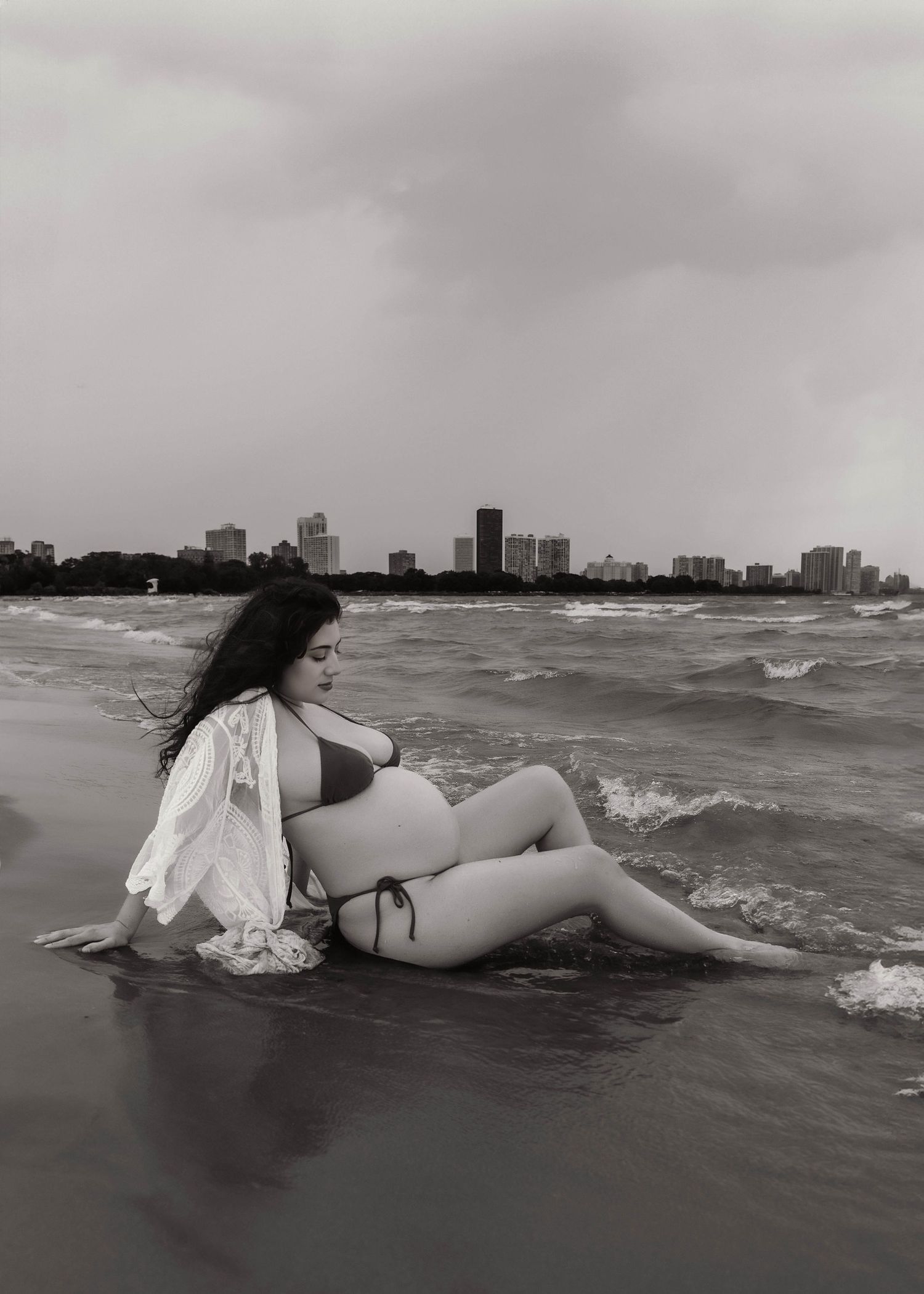 Beach Swim maternity session on overcast day on Montrose Beach in Chicago, IL